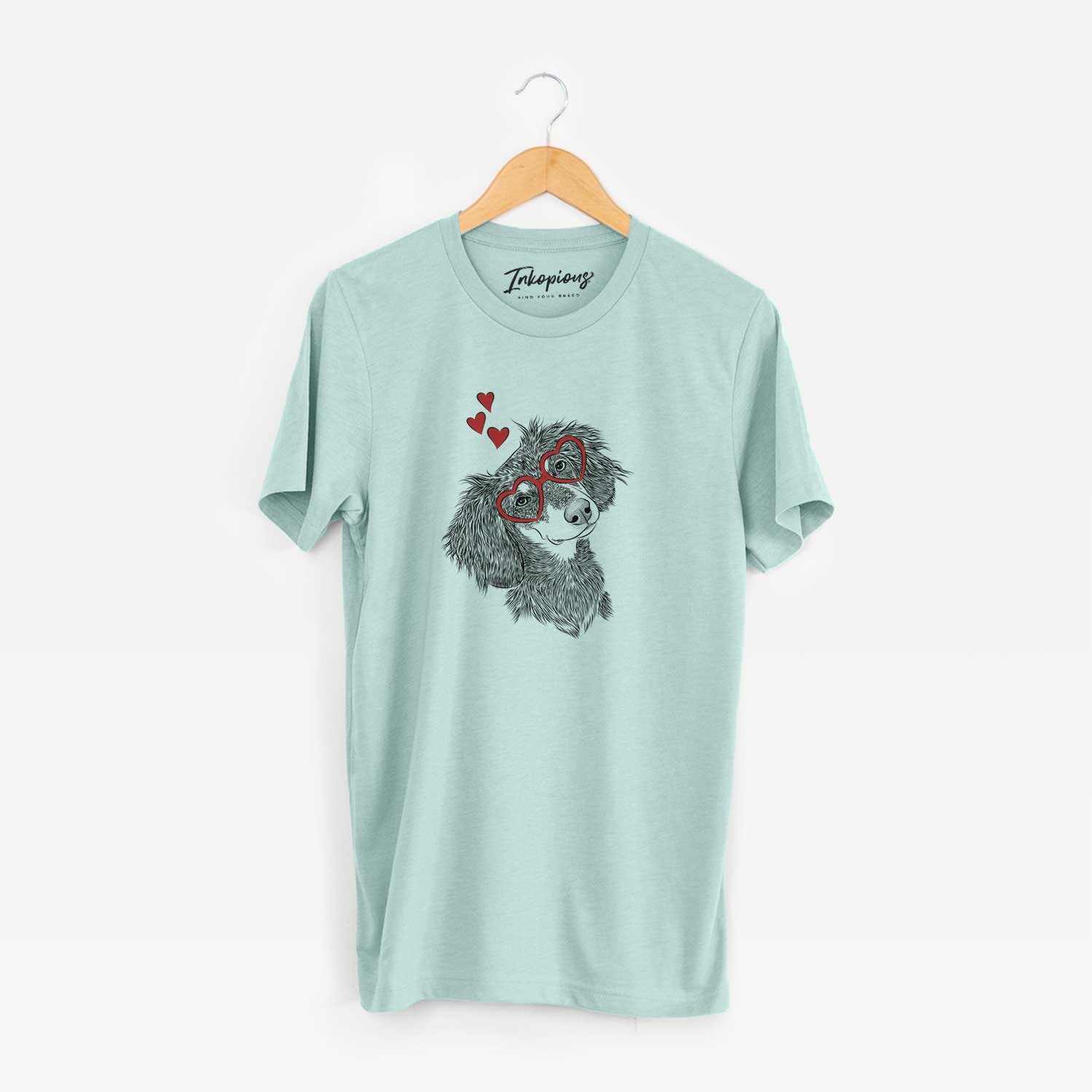 Hand-drawn sketch of Bailey the Long Haired Dachshund wearing heart-shaped glasses on a Heather Sage Unisex crewneck