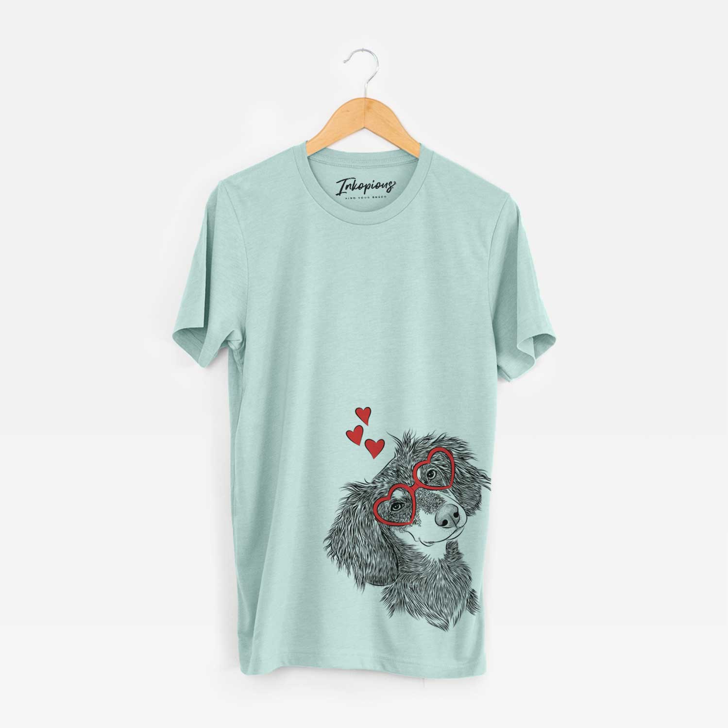 Hand-drawn sketch of Bailey the Long Haired Dachshund wearing heart-shaped glasses on a Heather Sage Unisex crewneck