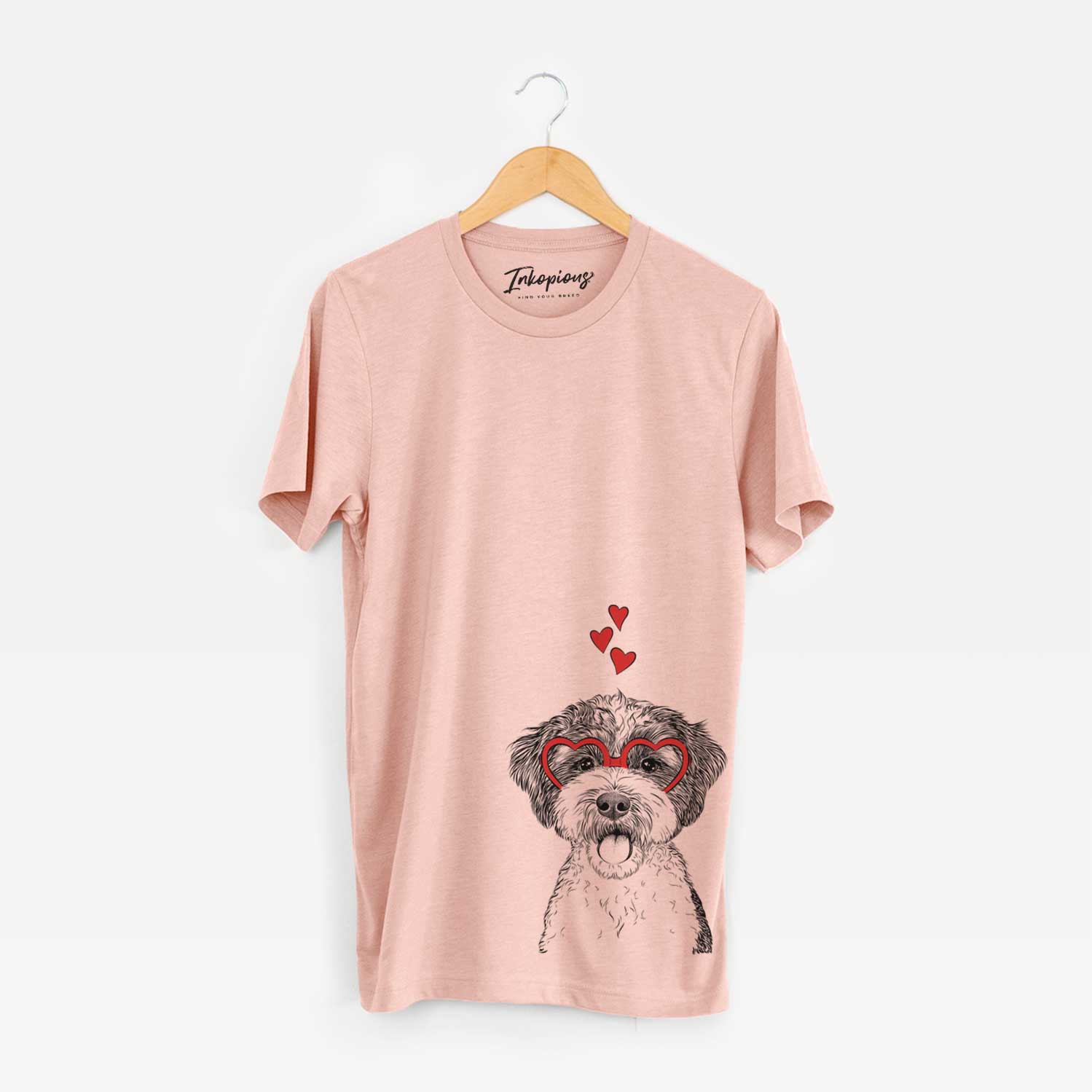 Hand-drawn sketch of Bella the Cockapoo wearing heart-shaped glasses on a Peach Unisex crewneck