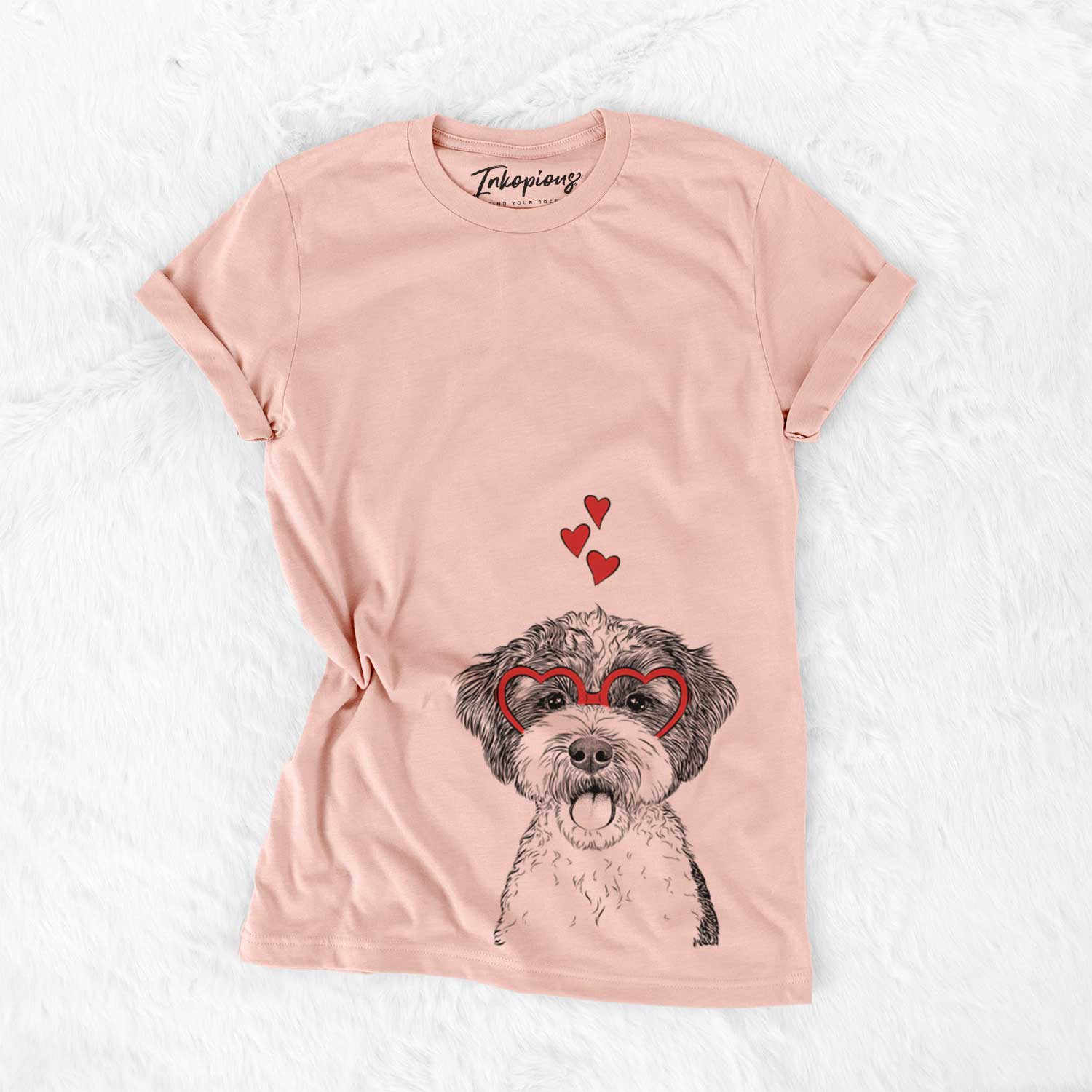 Hand-drawn sketch of Bella the Cockapoo wearing heart-shaped glasses on a Peach Bella Canvas Unisex Crewneck
