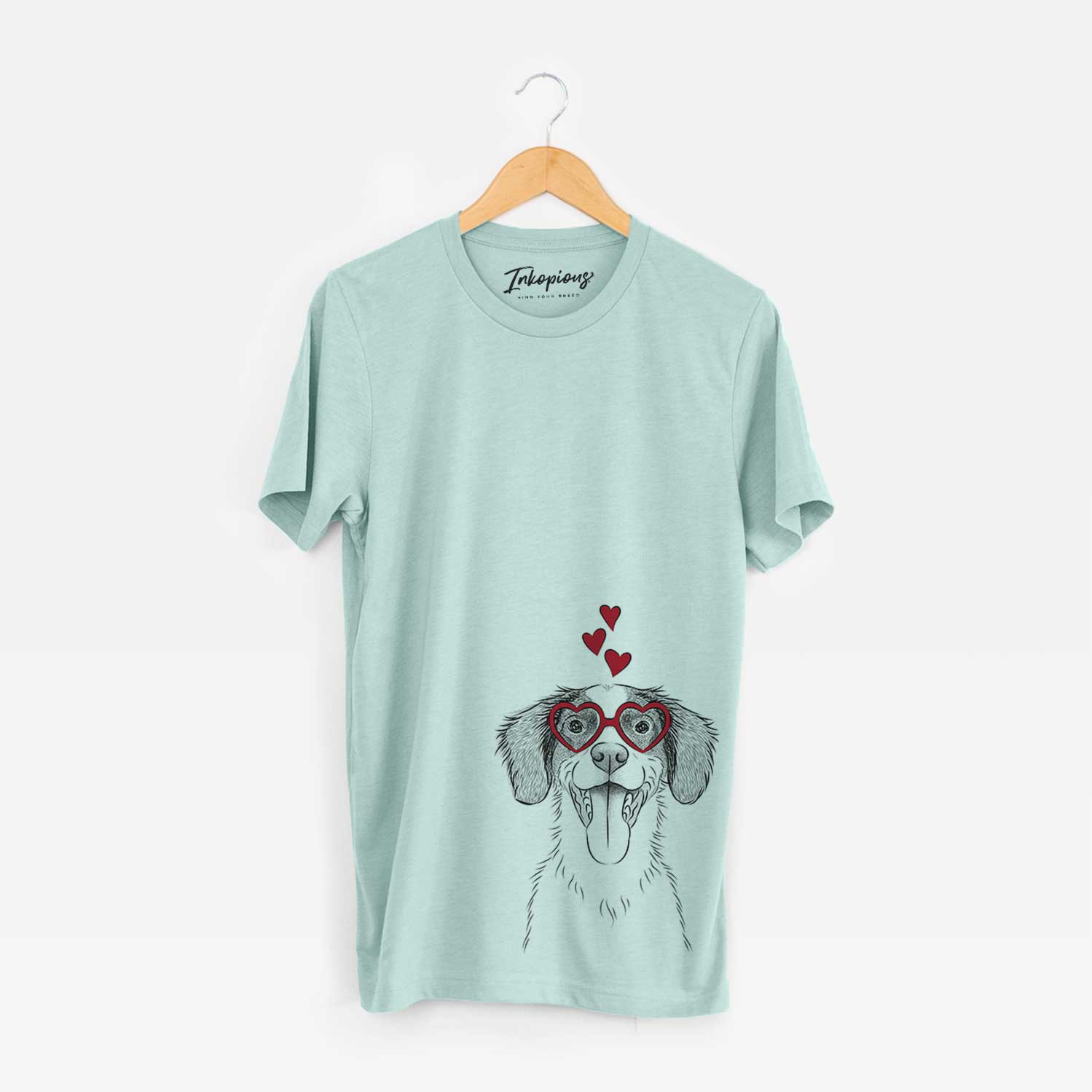 Hand-drawn sketch of Birdie the Brittany wearing heart-shaped glasses on a Heather Sage Bella Canvas Unisex Crewneck