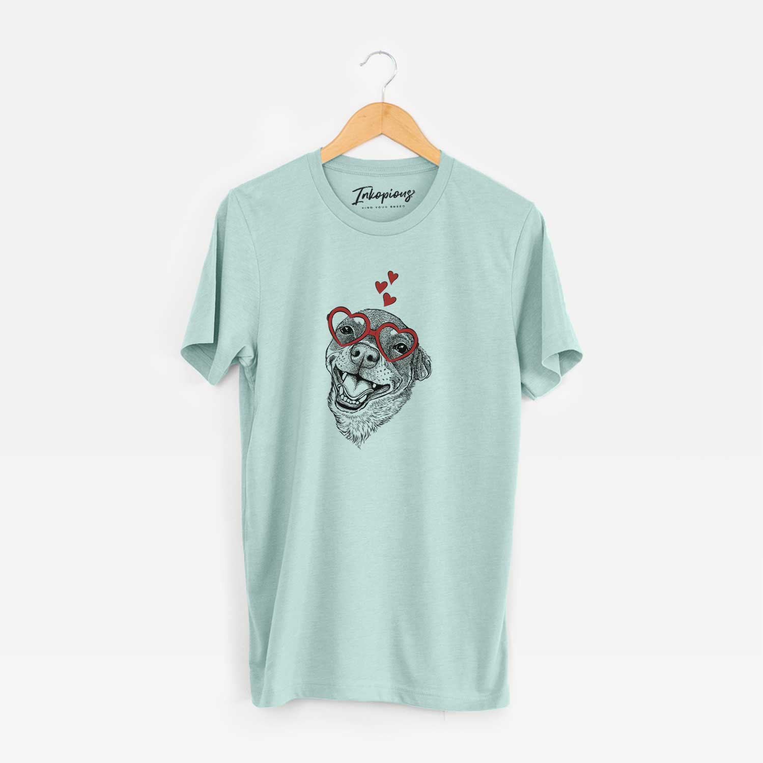 Hand-drawn sketch of Boss the Chihuahua wearing heart-shaped glasses on a Heather Sage Unisex crewneck