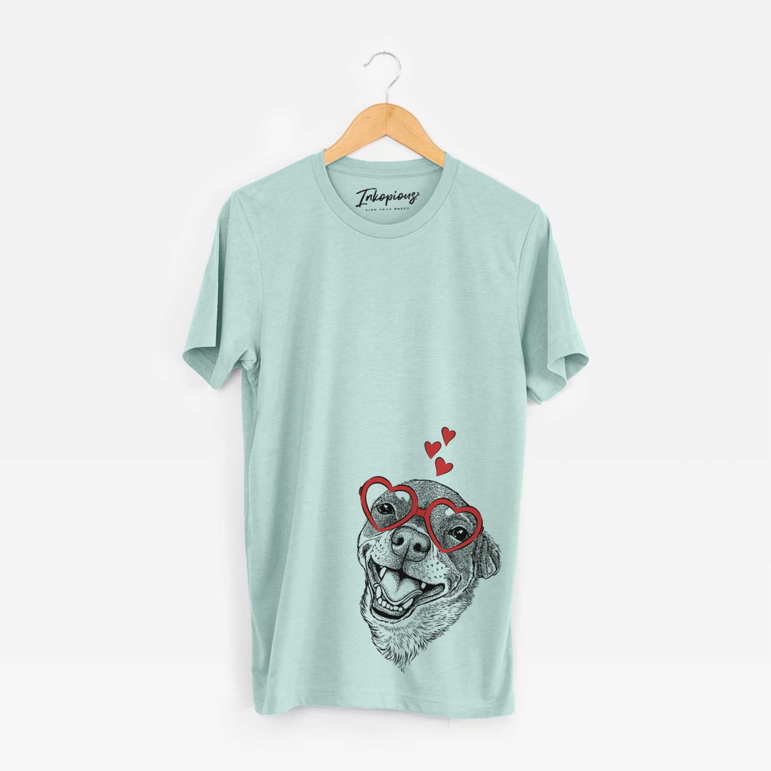 Hand-drawn sketch of Boss the Chihuahua wearing heart-shaped glasses on a Heather Sage Unisex crewneck