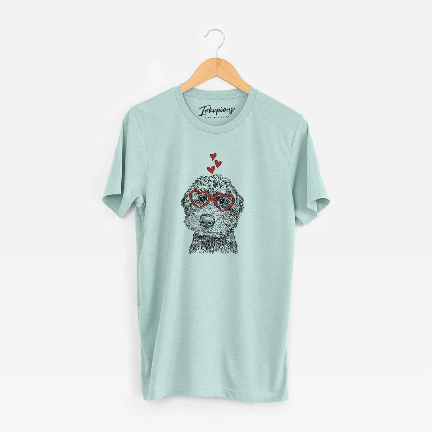 Hand-drawn sketch of Bowser the Whoodle wearing heart-shaped glasses on a Heather Sage Unisex crewneck