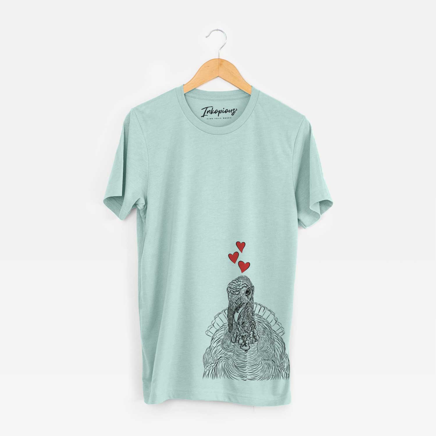 Hand-drawn sketch of Brady the Turkey wearing heart-shaped glasses on a Heather Sage Unisex crewneck