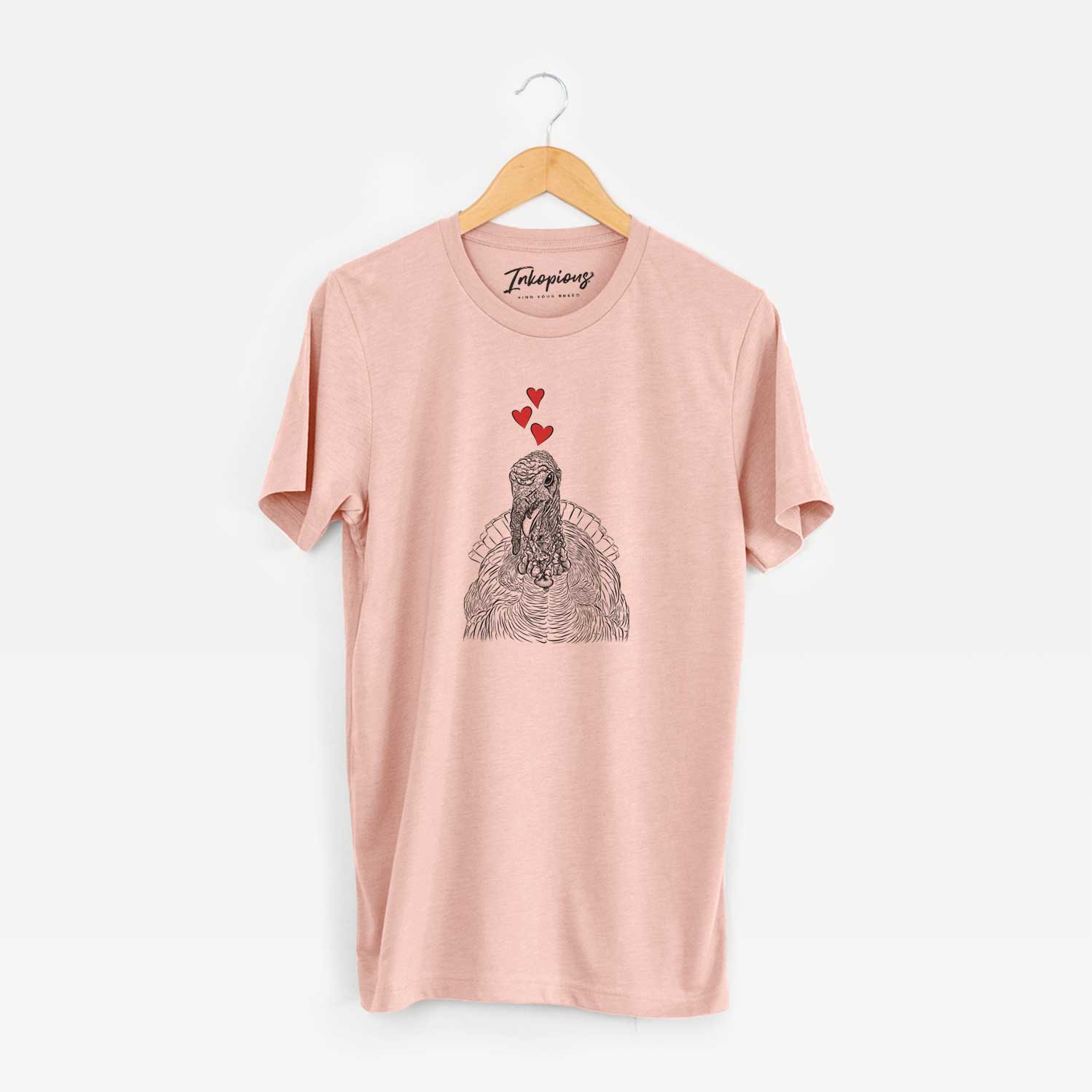 Hand-drawn sketch of Brady the Turkey wearing heart-shaped glasses on a Peach Unisex crewneck