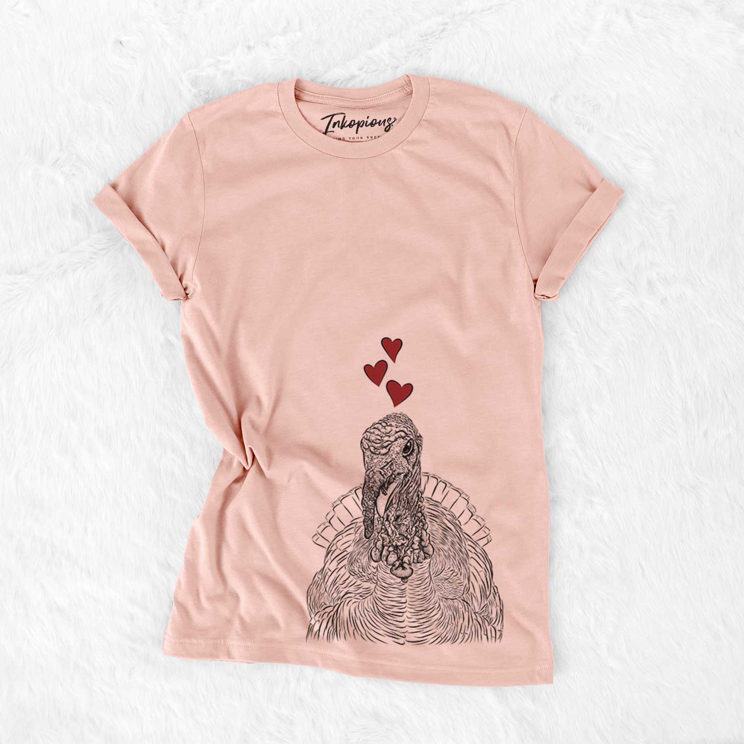 Hand-drawn sketch of Brady the Turkey wearing heart-shaped glasses on a Peach Bella Canvas Unisex Crewneck