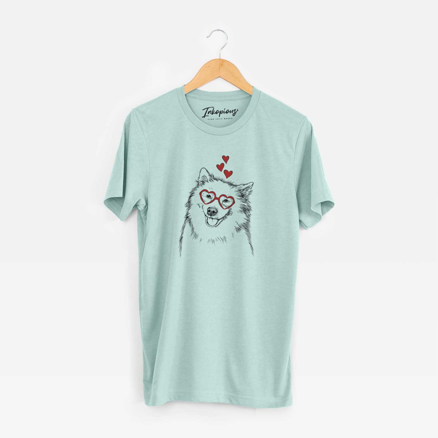 Hand-drawn sketch of Caico the Samoyed wearing heart-shaped glasses on a Heather Sage Unisex crewneck