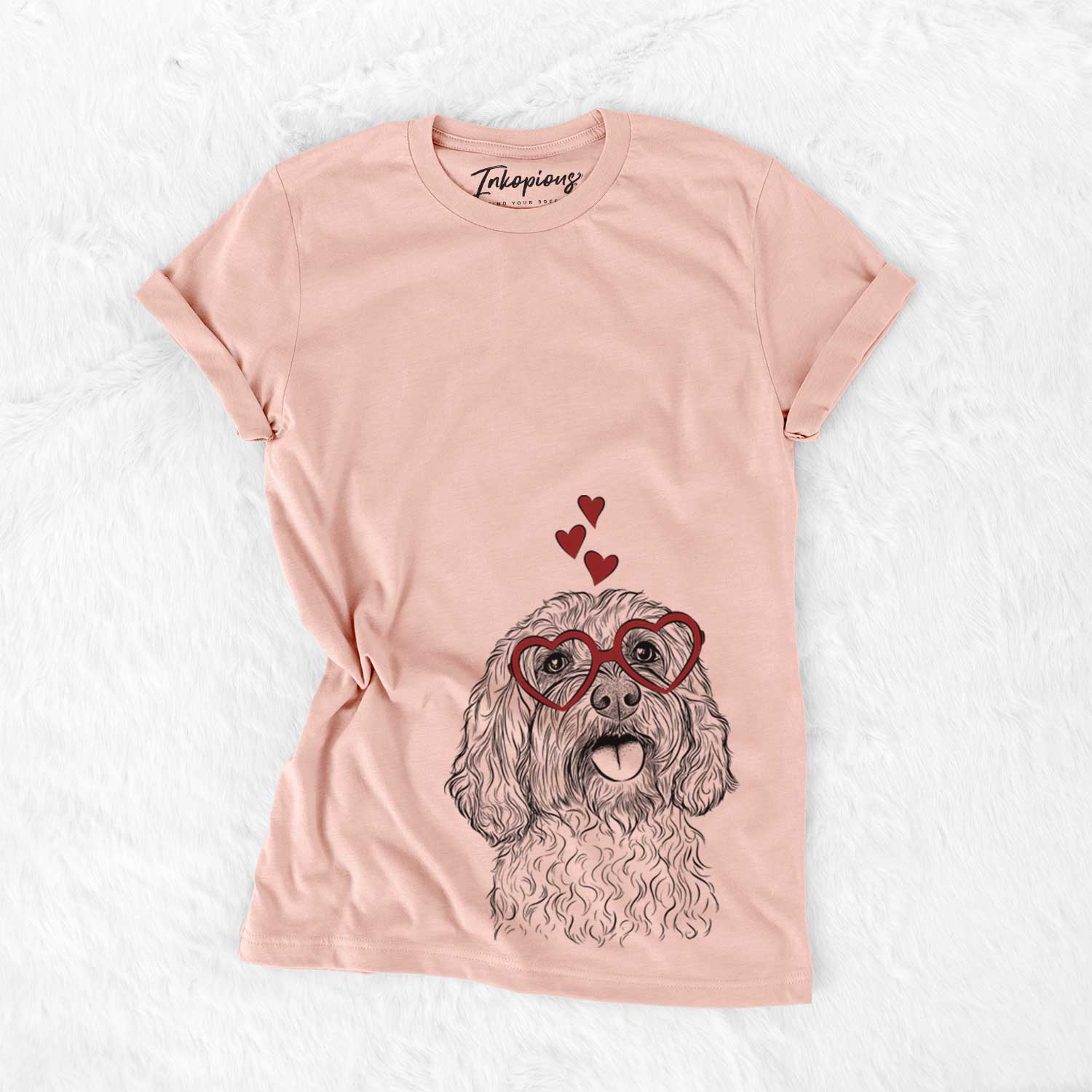 Hand-drawn sketch of Cali the Cavapoo wearing heart-shaped glasses on a Peach Bella Canvas Unisex Crewneck
