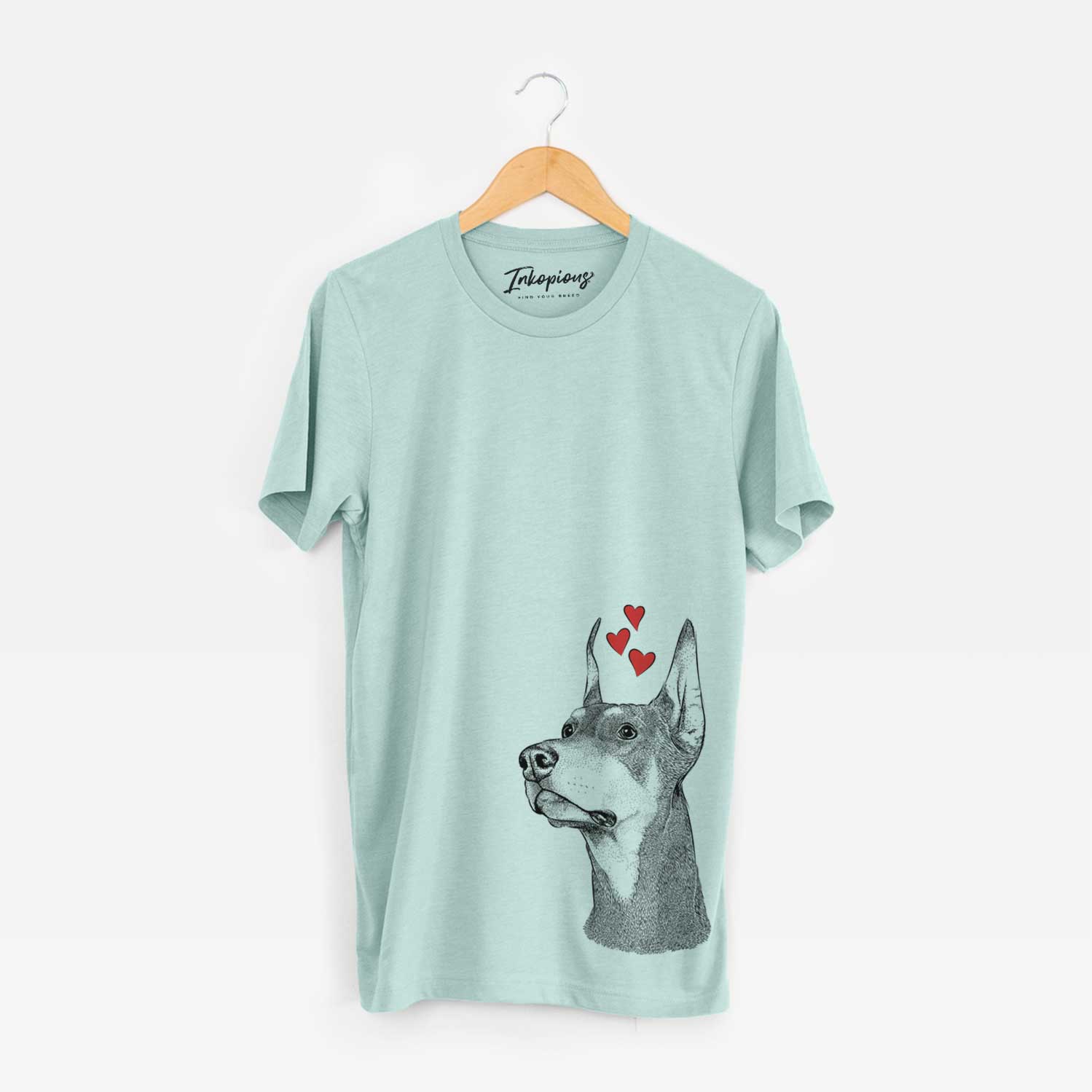 Hand-drawn sketch of Cenza the Doberman Pinscher wearing heart-shaped glasses on a Heather Sage Unisex crewneck