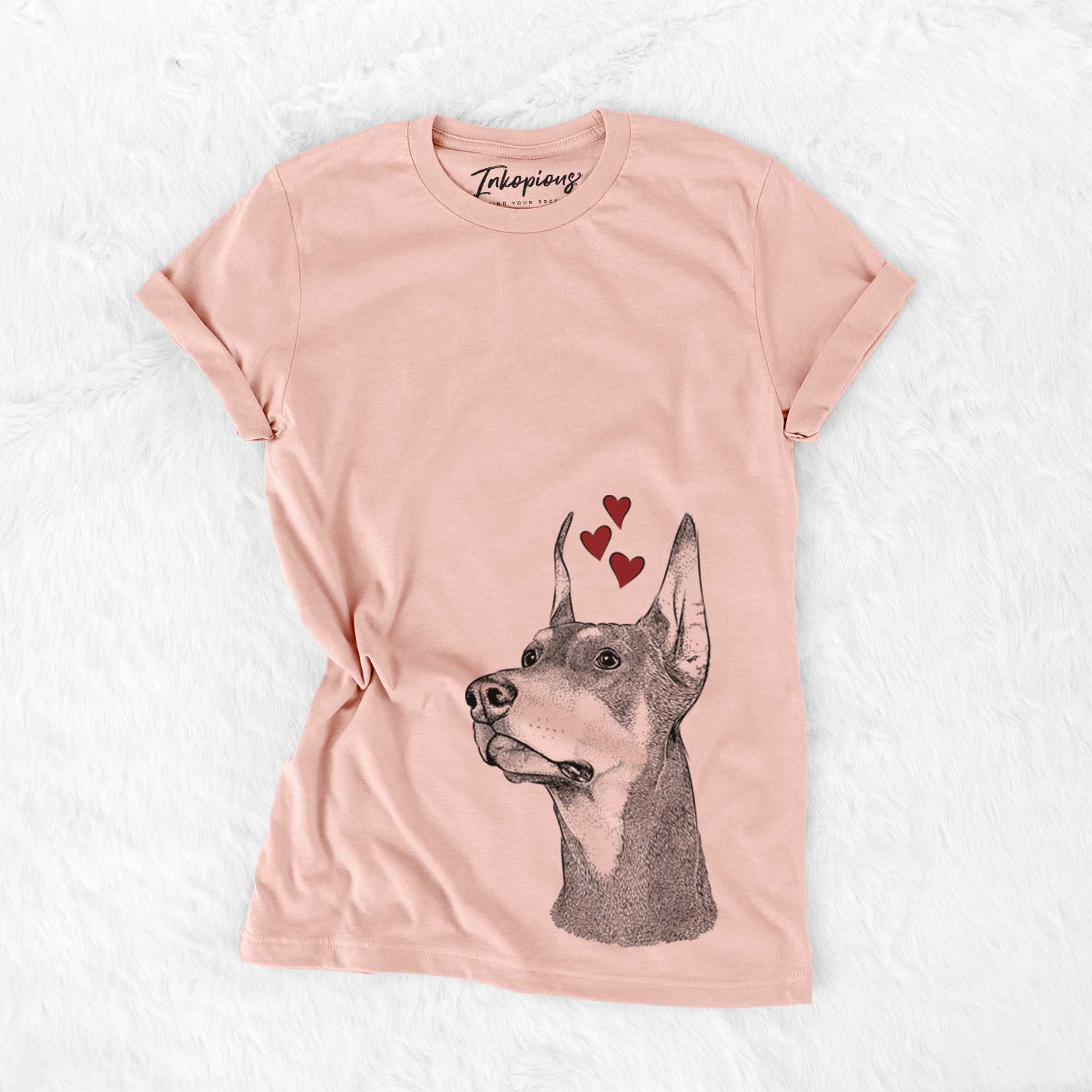 Hand-drawn sketch of Cenza the Doberman Pinscher wearing heart-shaped glasses on a Peach Bella Canvas Unisex Crewneck