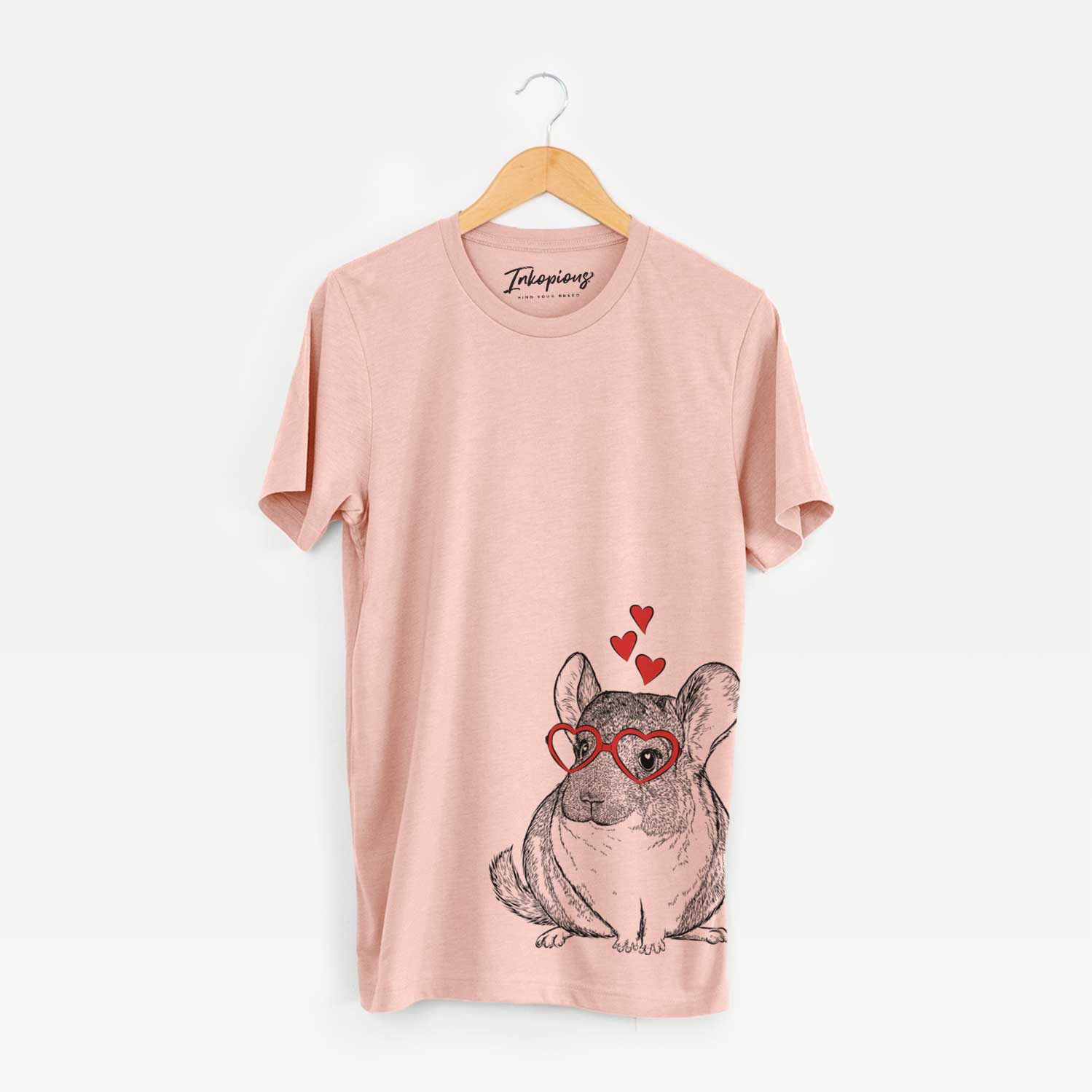 Hand-drawn sketch of Cheddar the Chinchilla wearing heart-shaped glasses on a Peach Unisex crewneck
