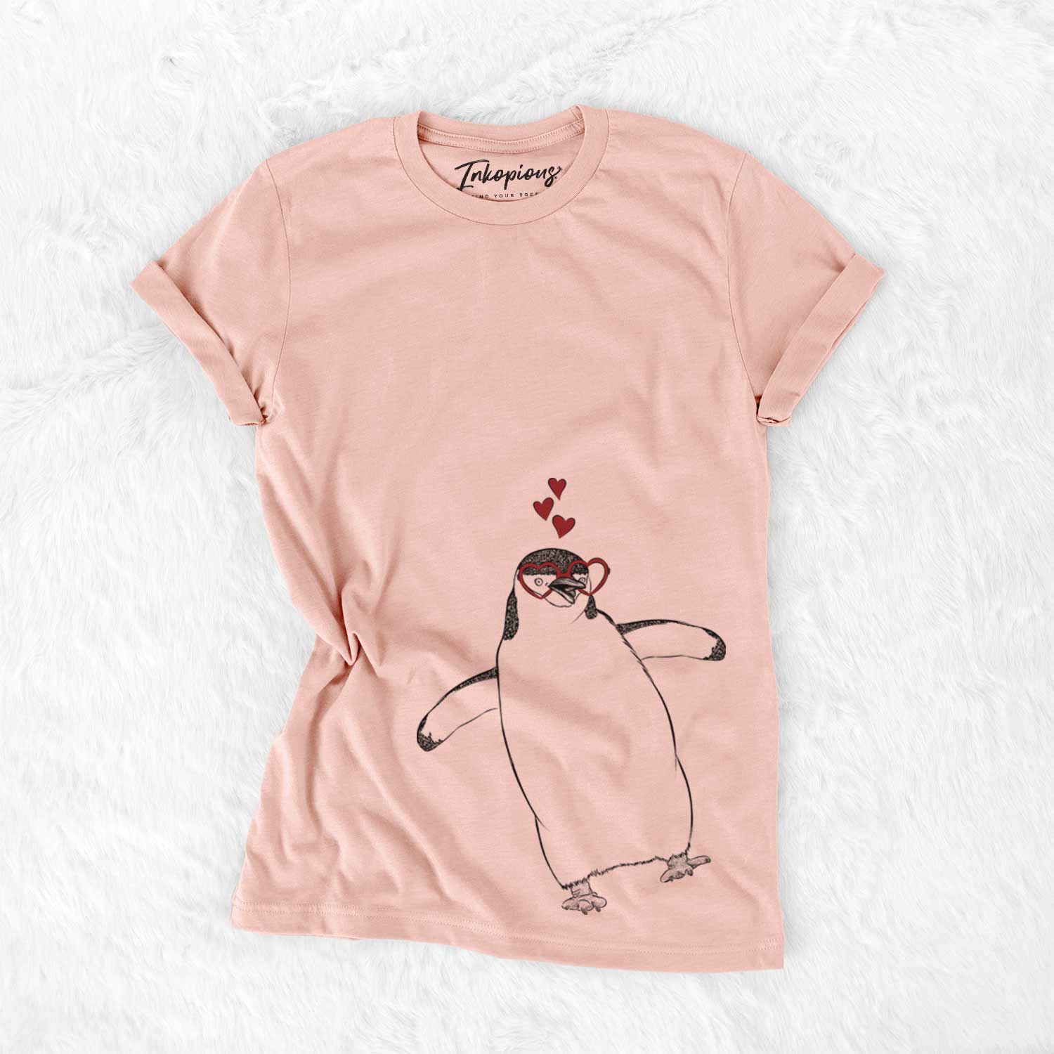 Hand-drawn sketch of Chive the Chinstrap Penguin wearing heart-shaped glasses on a Peach Bella Canvas Unisex Crewneck