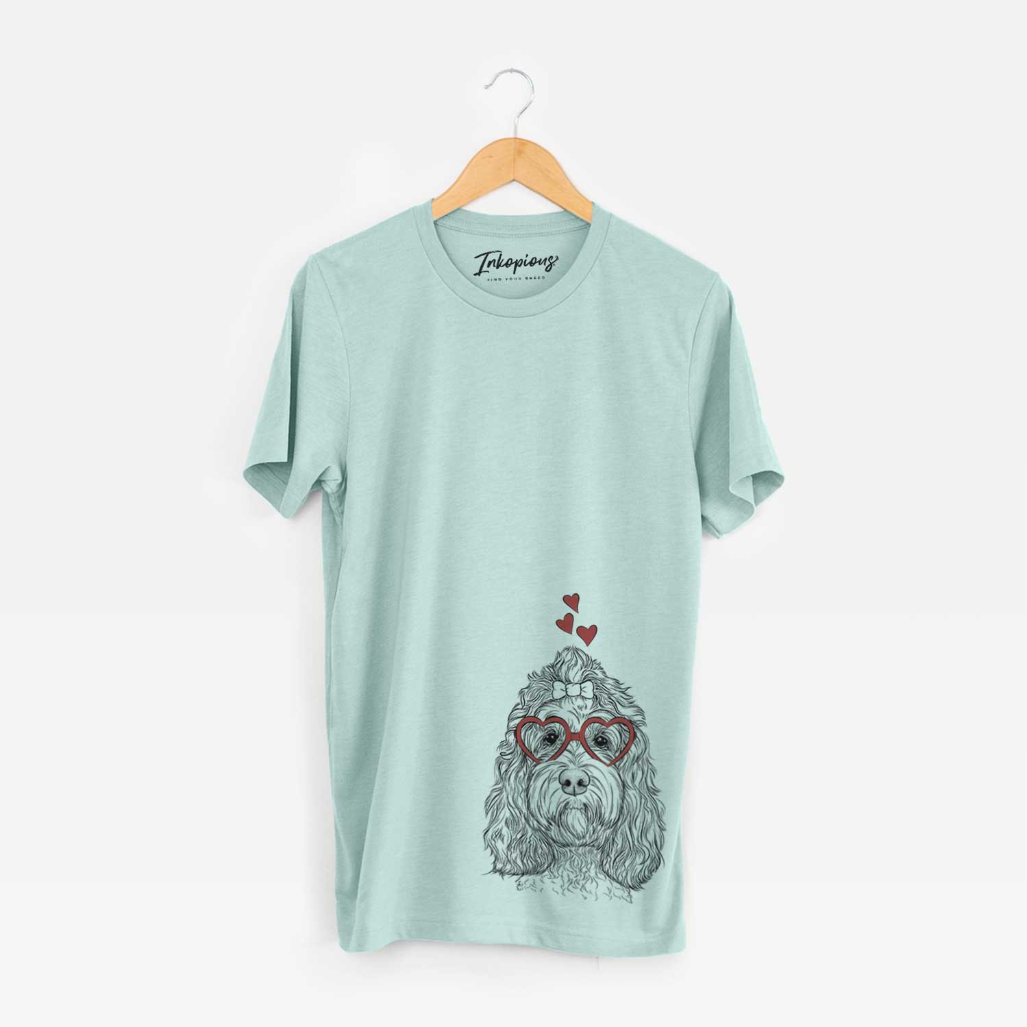 Hand-drawn sketch of Chloe the Cockapoo wearing heart-shaped glasses on a Heather Sage Unisex crewneck