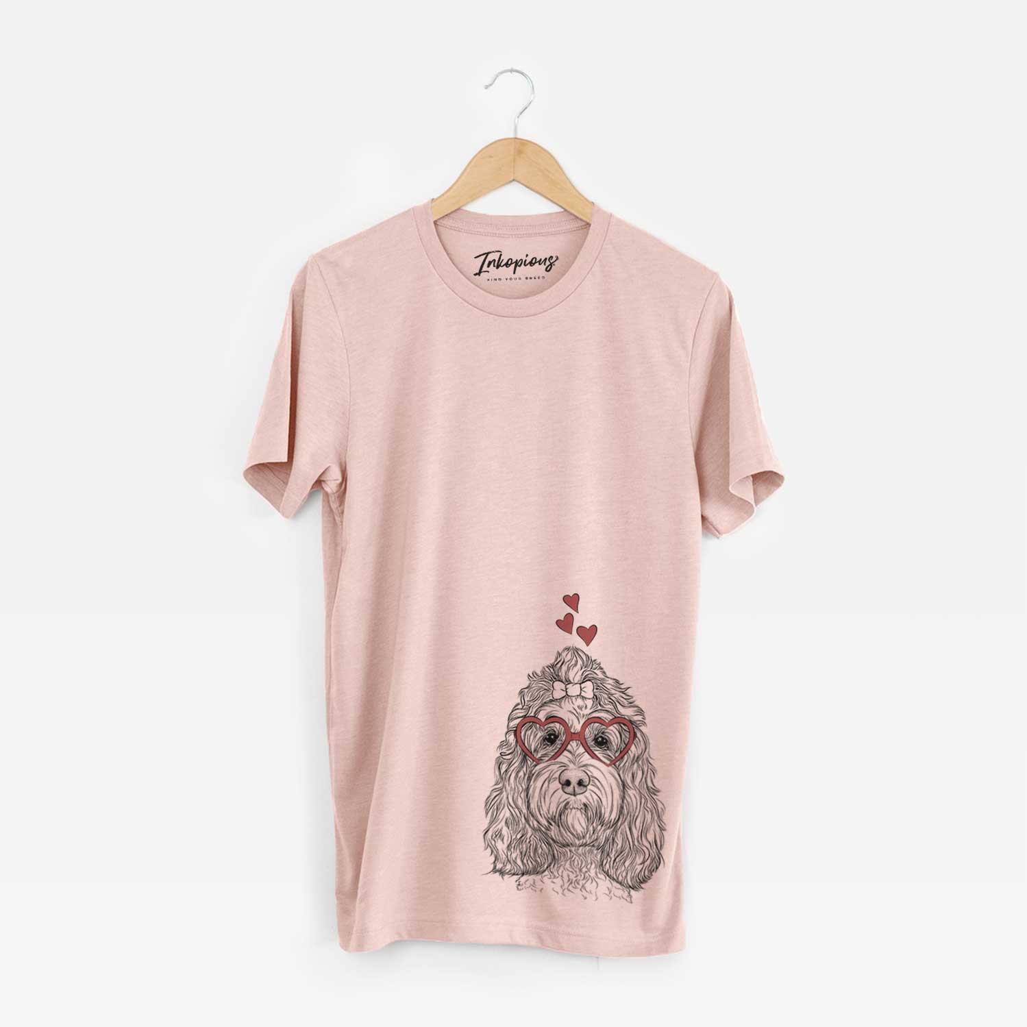 Hand-drawn sketch of Chloe the Cockapoo wearing heart-shaped glasses on a Peach Unisex crewneck