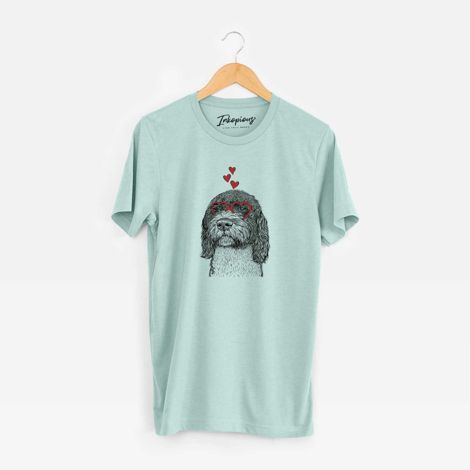 Hand-drawn sketch of Chris the Portuguese Water Dog wearing heart-shaped glasses on a Heather Sage Unisex crewneck