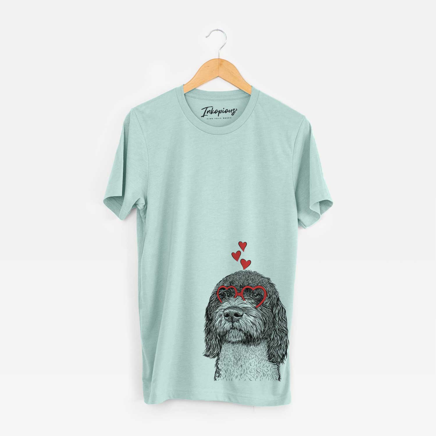 Hand-drawn sketch of Chris the Portuguese Water Dog wearing heart-shaped glasses on a Heather Sage Unisex crewneck