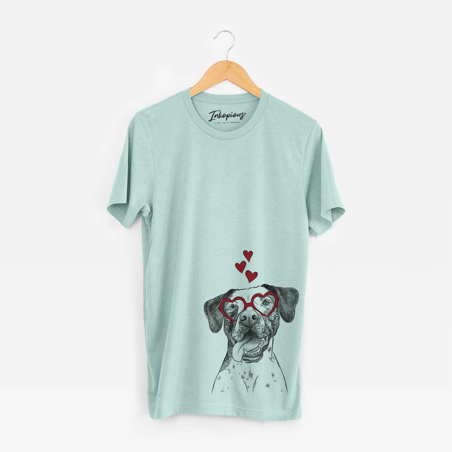 Hand-drawn sketch of Cola the Catahoula wearing heart-shaped glasses on a Heather Sage Bella Canvas Unisex Crewneck