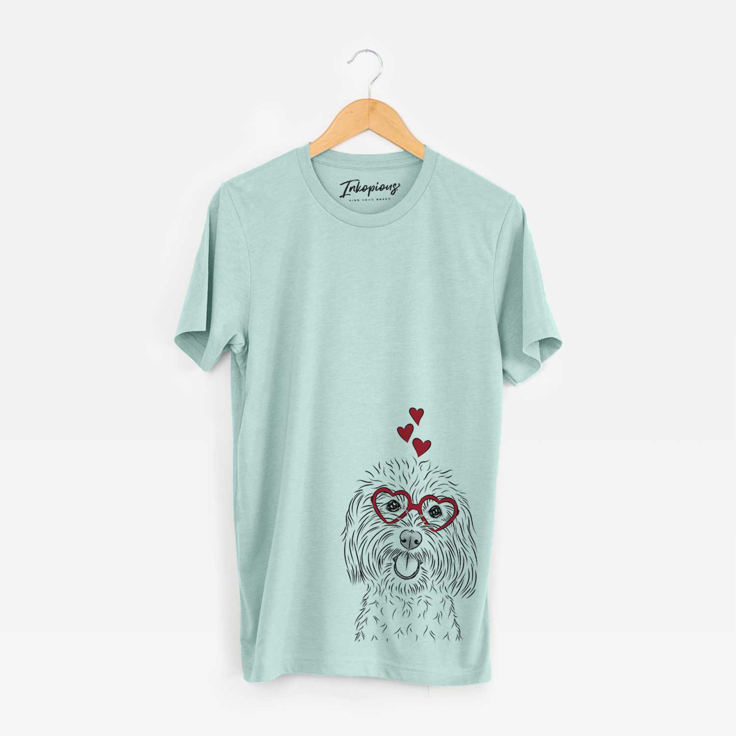 Hand-drawn sketch of Cuddles the Coton de Tulear wearing heart-shaped glasses on a Heather Sage Bella Canvas Unisex Crewneck