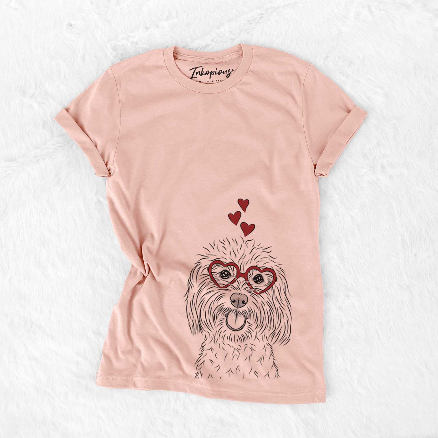 Hand-drawn sketch of Cuddles the Coton de Tulear wearing heart-shaped glasses on a Peach Bella Canvas Unisex Crewneck