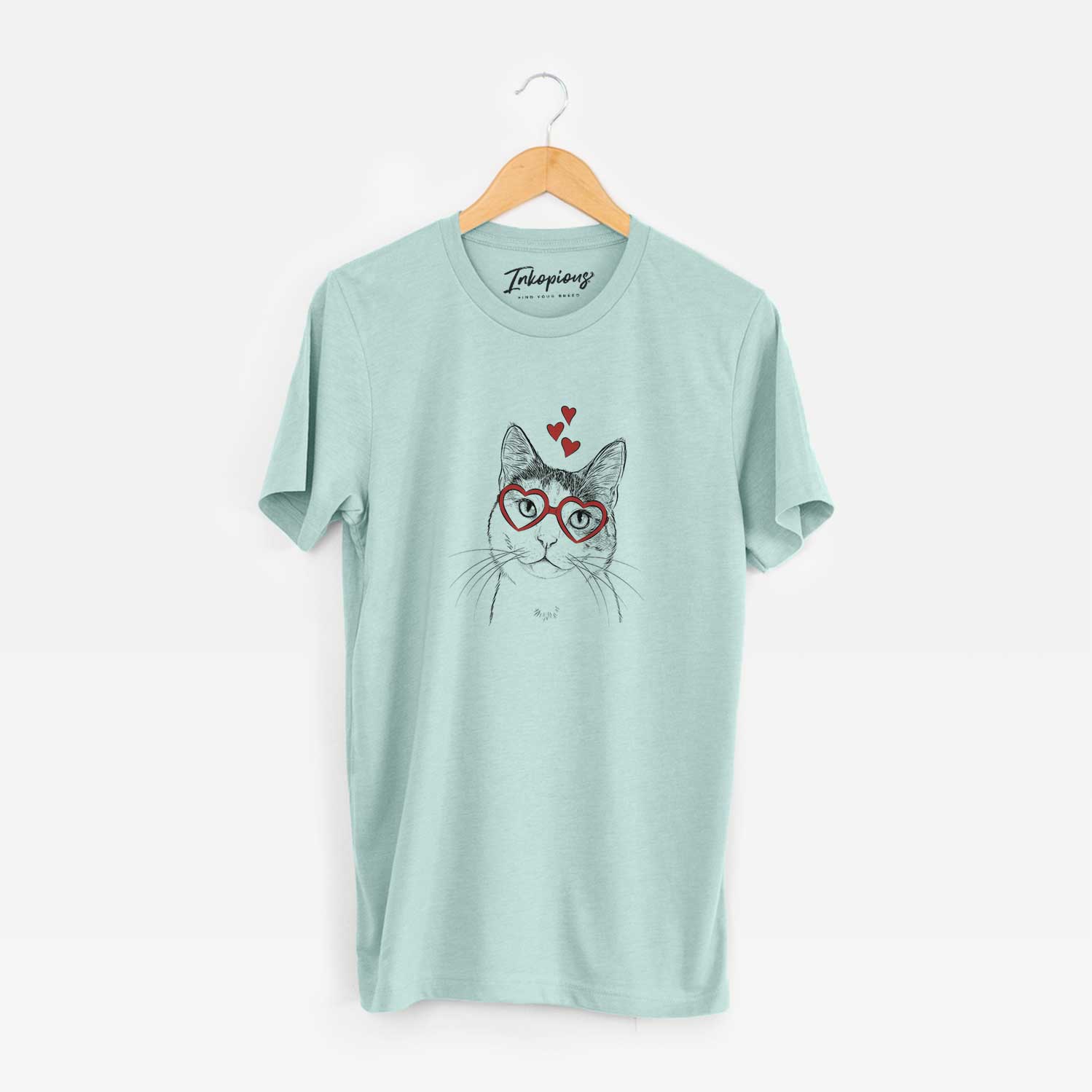 Hand-drawn sketch of Denver the Calico Cat wearing heart-shaped glasses on a Heather Sage Unisex crewneck