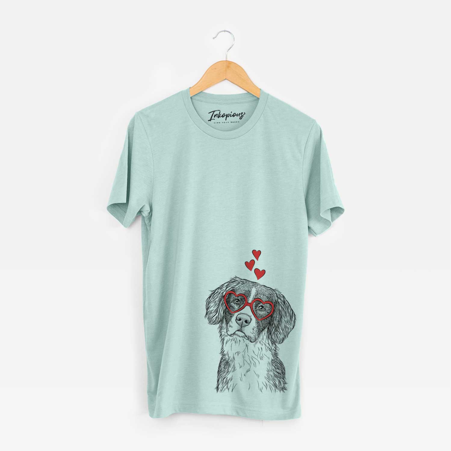 Hand-drawn sketch of Dulce the Drentsche Patrijshond wearing heart-shaped glasses on a Heather Sage Unisex crewneck