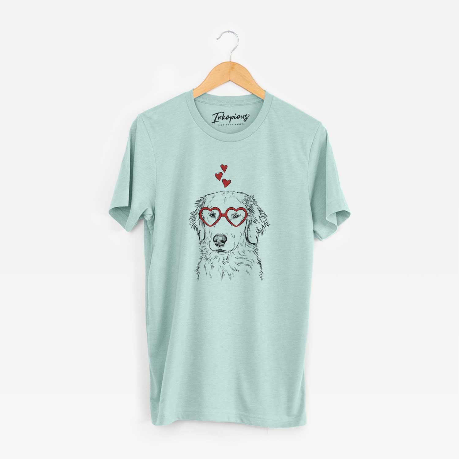 Hand-drawn sketch of Eli the Golden Retriever wearing heart-shaped glasses on a Heather Sage Unisex crewneck