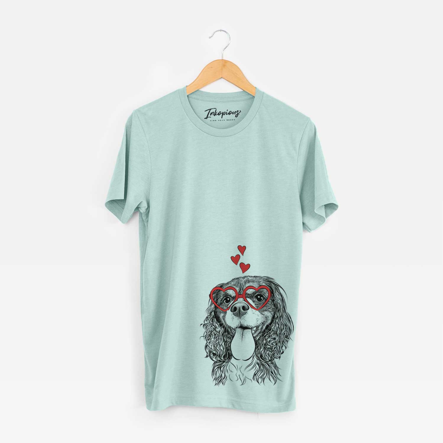 Hand-drawn sketch of Elizabeth the Cavalier King Charles Spaniel wearing heart-shaped glasses on a Heather Sage Bella Canvas Unisex Crewneck