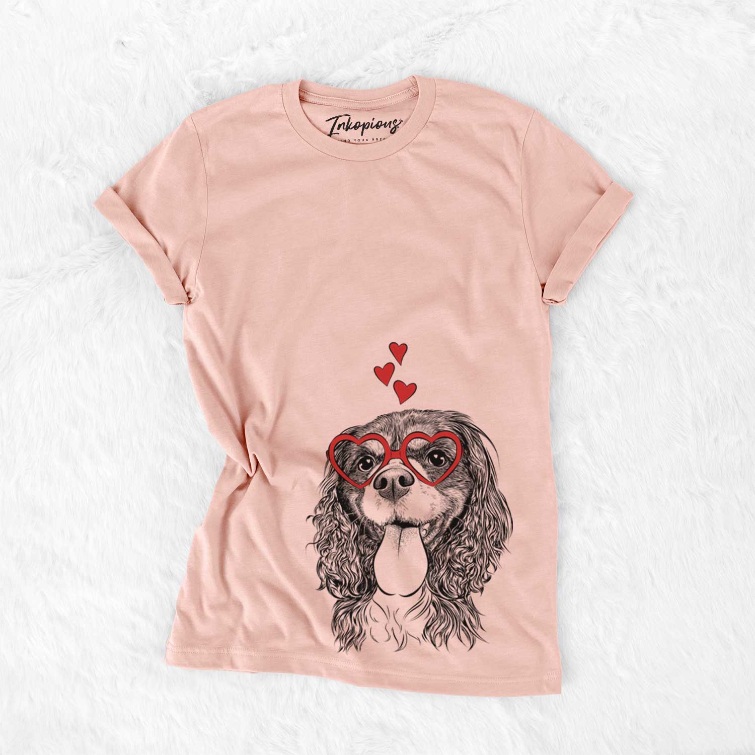 Hand-drawn sketch of Elizabeth the Cavalier King Charles Spaniel wearing heart-shaped glasses on a Peach Bella Canvas Unisex Crewneck