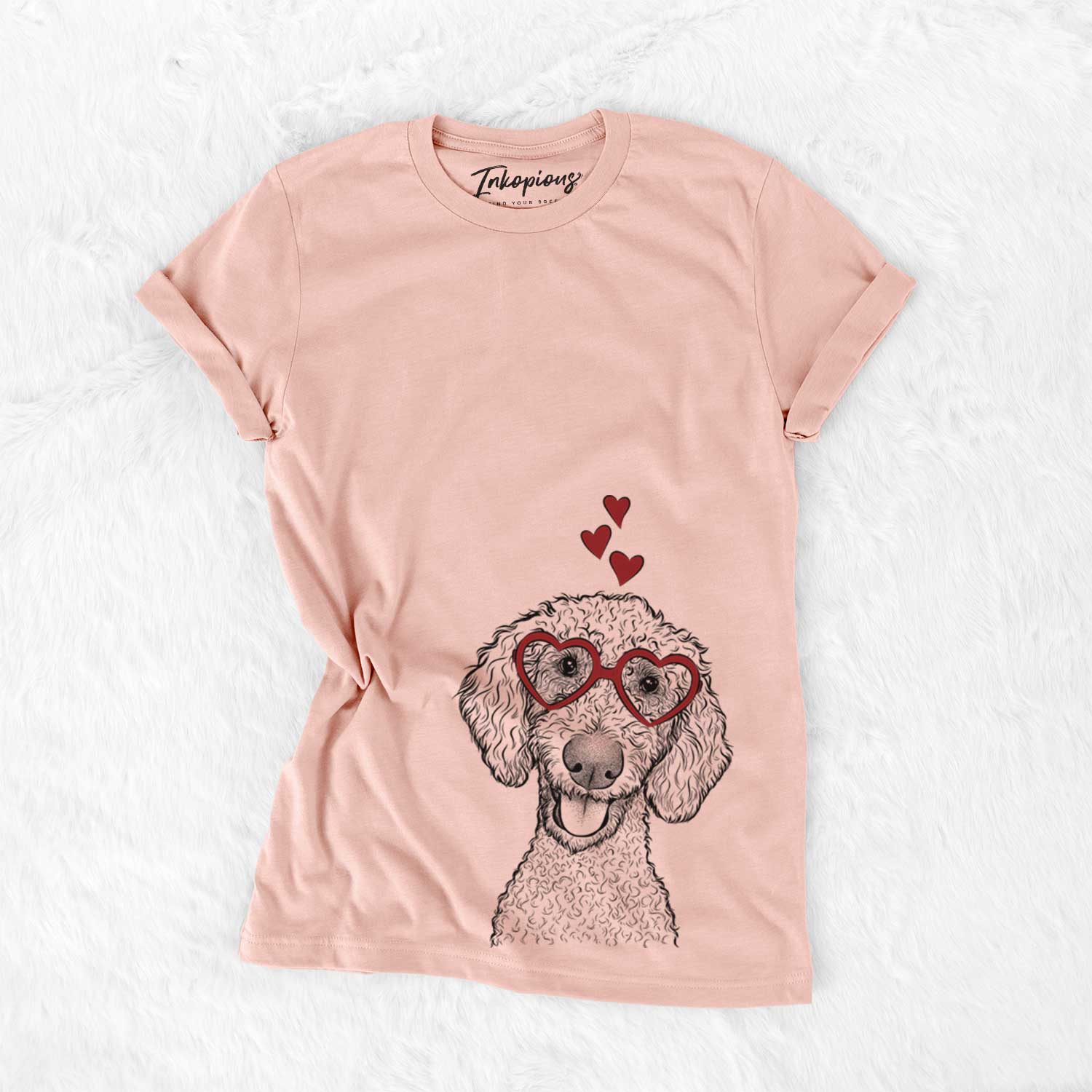 Hand-drawn sketch of Fenway the Goldendoodle wearing heart-shaped glasses on a Peach Bella Canvas Unisex Crewneck