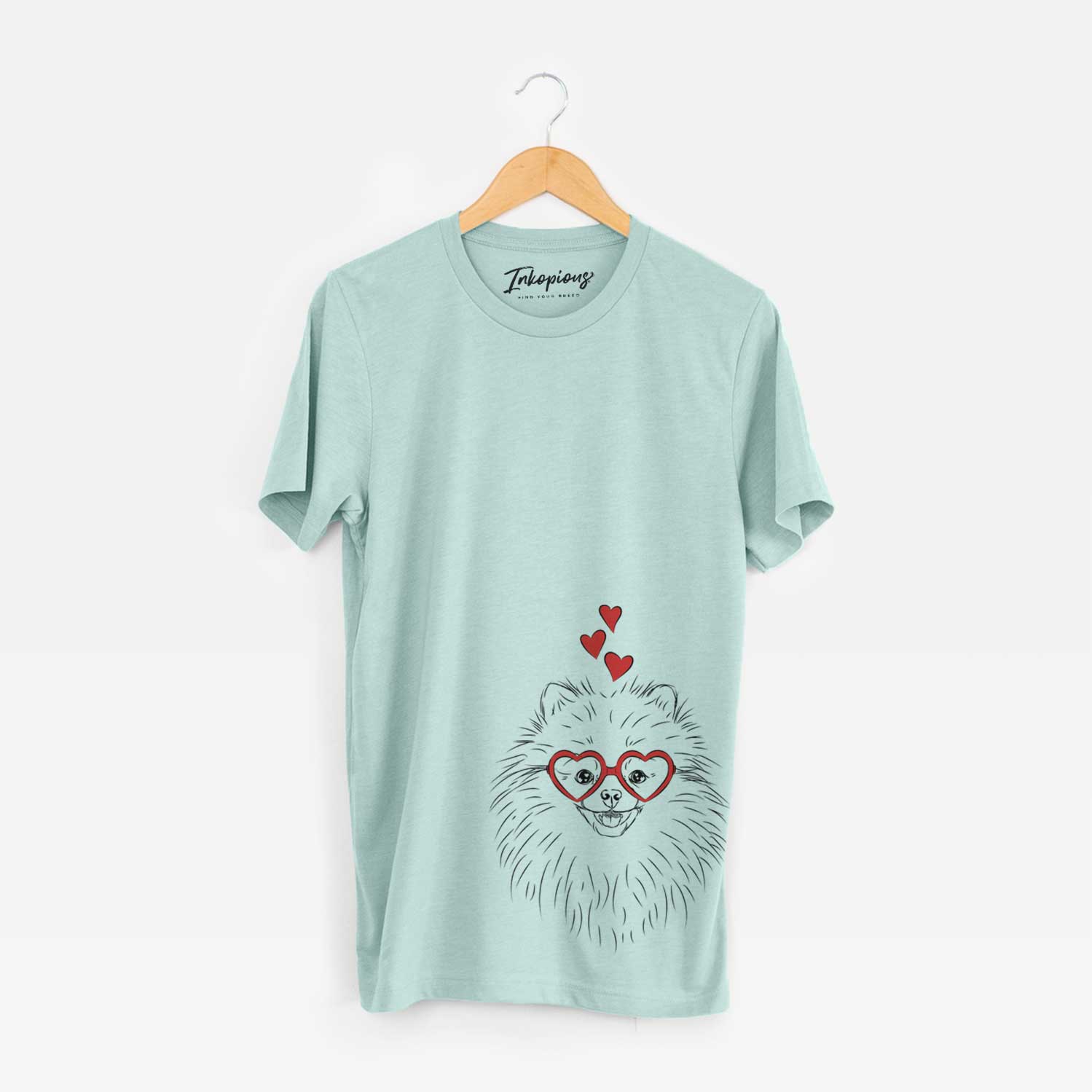 Hand-drawn sketch of Finn the Pomeranian wearing heart-shaped glasses on a Heather Sage Bella Canvas Unisex Crewneck