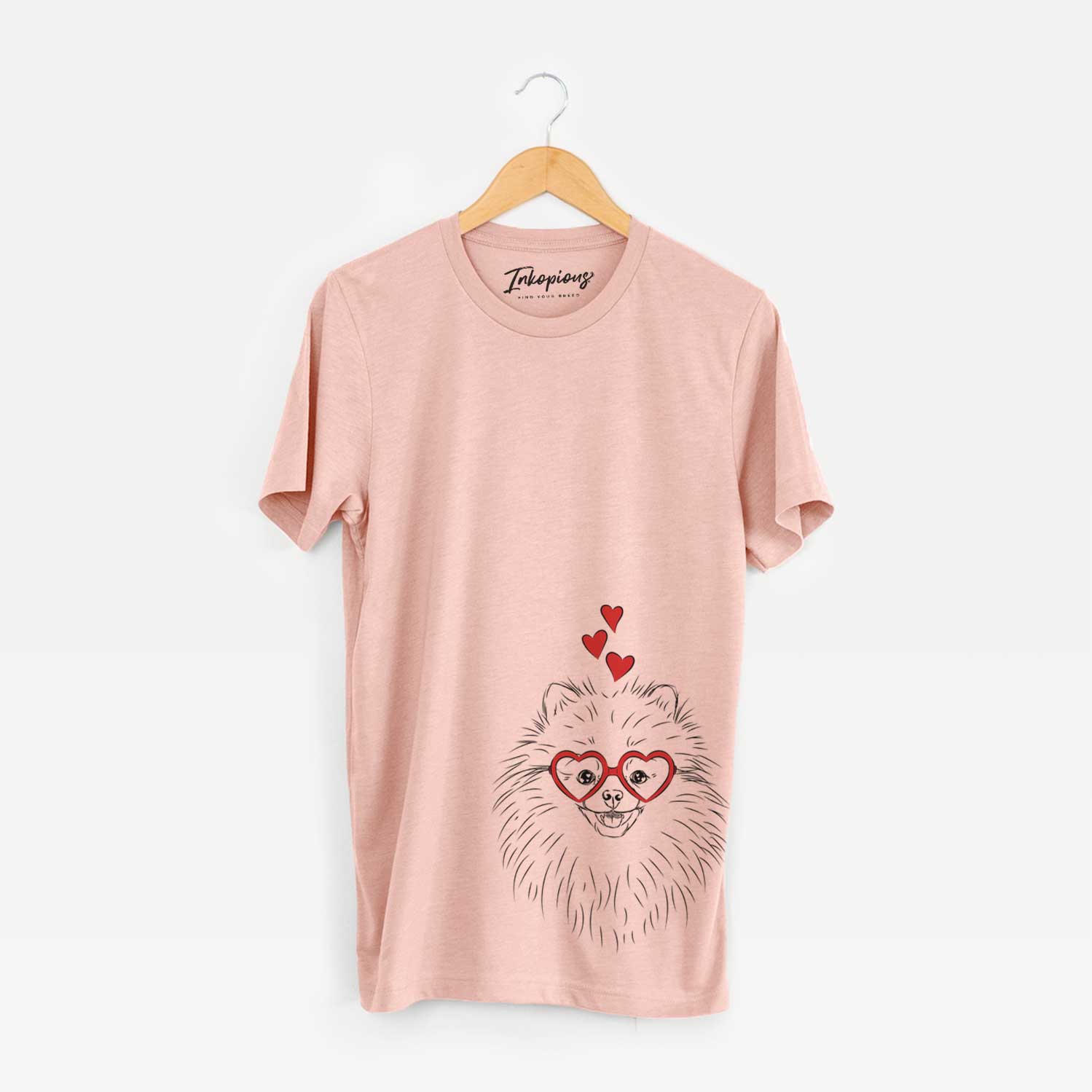 Hand-drawn sketch of Finn the Pomeranian wearing heart-shaped glasses on a Peach Unisex crewneck