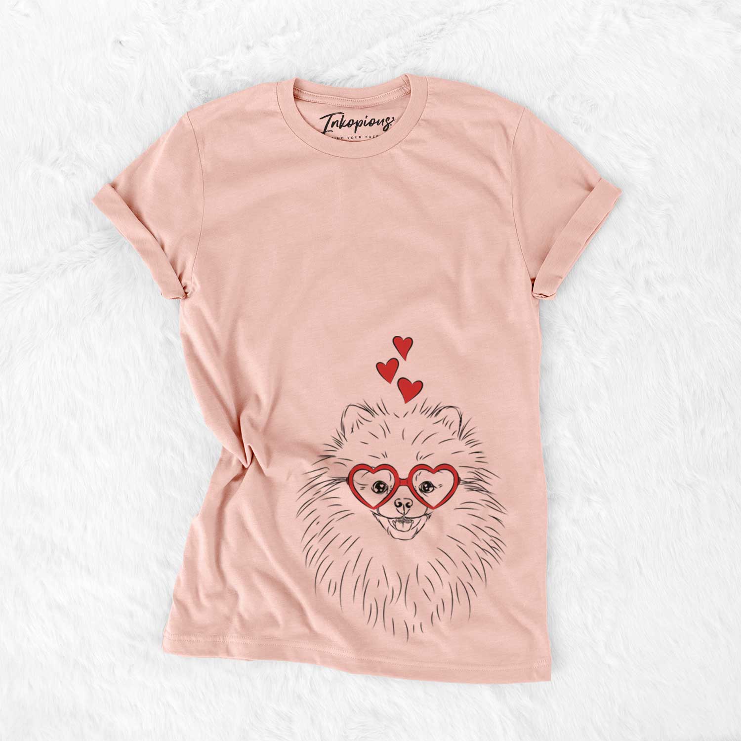 Hand-drawn sketch of Finn the Pomeranian wearing heart-shaped glasses on a Peach Bella Canvas Unisex Crewneck
