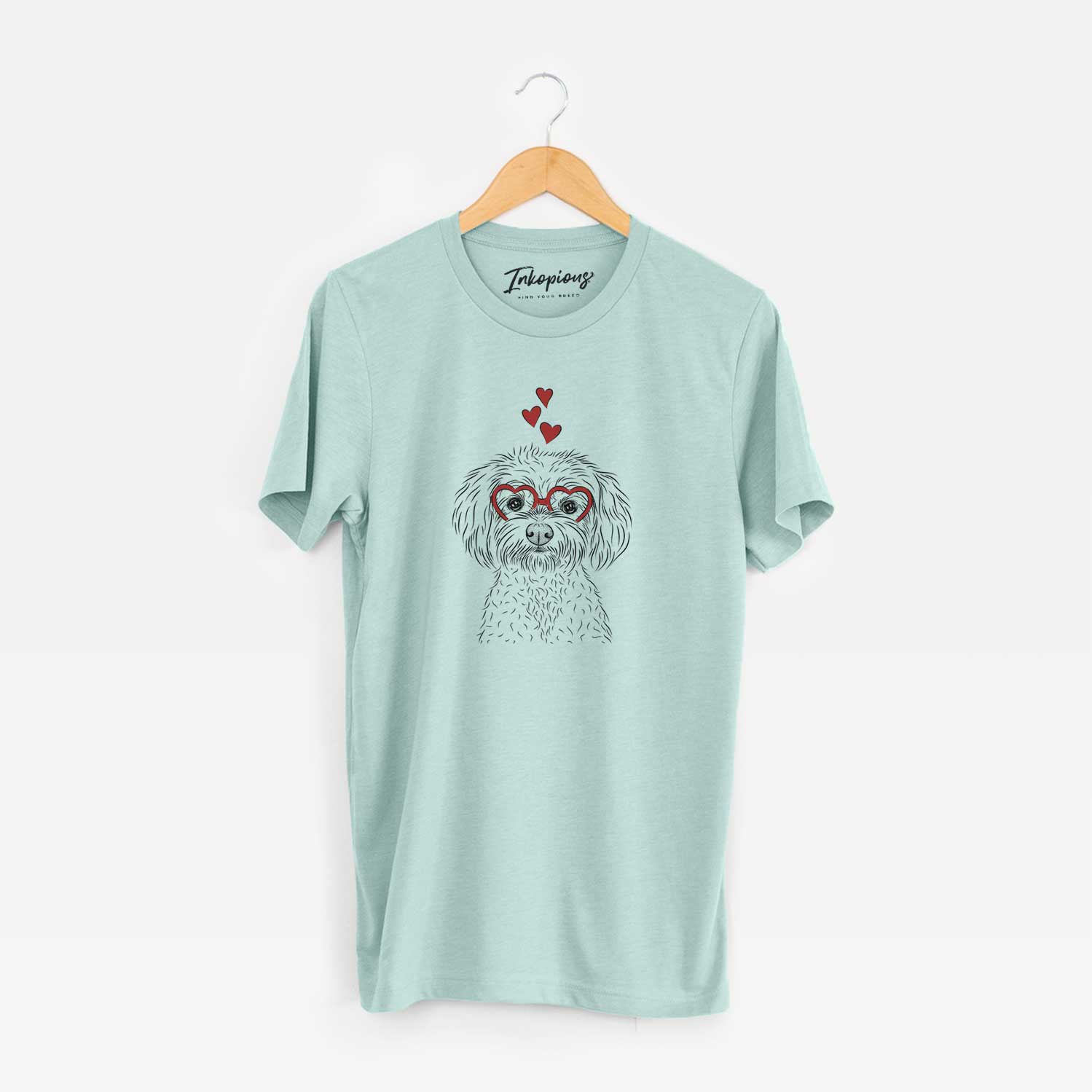 Hand-drawn sketch of Francesca the Maltipoo wearing heart-shaped glasses on a Heather Sage Unisex crewneck