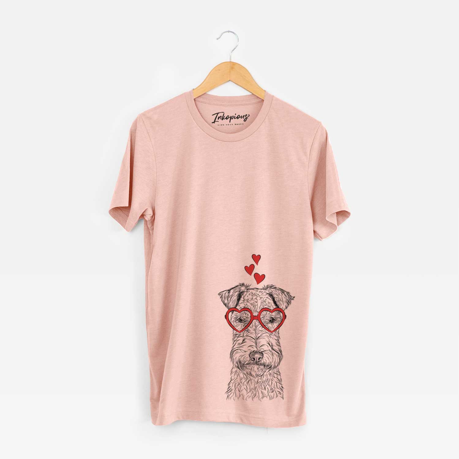 Hand-drawn sketch of Frida the Lakeland Terrier wearing heart-shaped glasses on a Peach Unisex crewneck