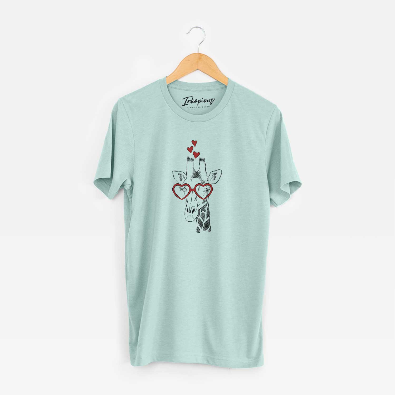 Hand-drawn sketch of Geoffrey the Giraffe wearing heart-shaped glasses on a Heather Sage Unisex crewneck