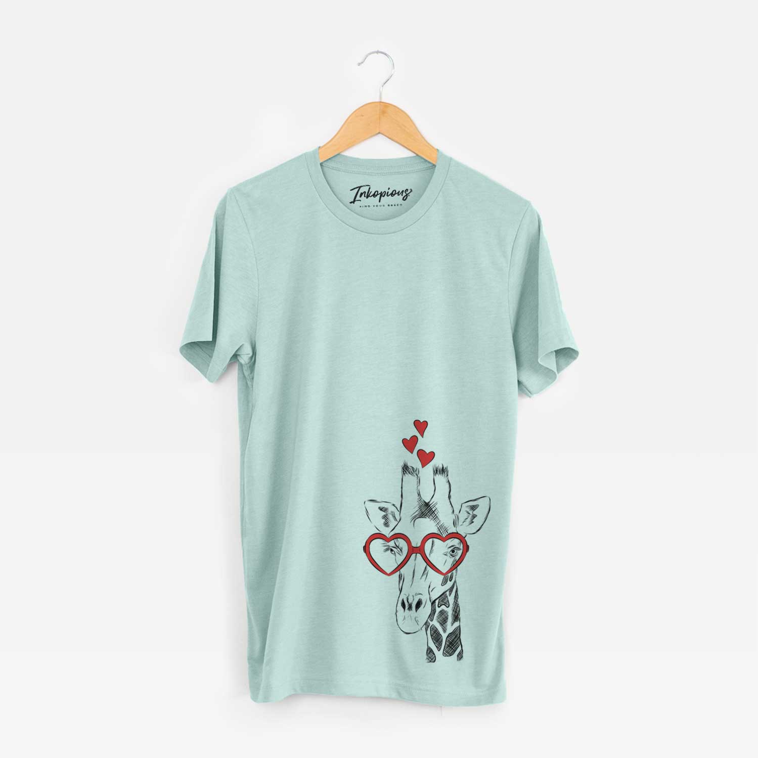 Hand-drawn sketch of Geoffrey the Giraffe wearing heart-shaped glasses on a Heather Sage Unisex crewneck
