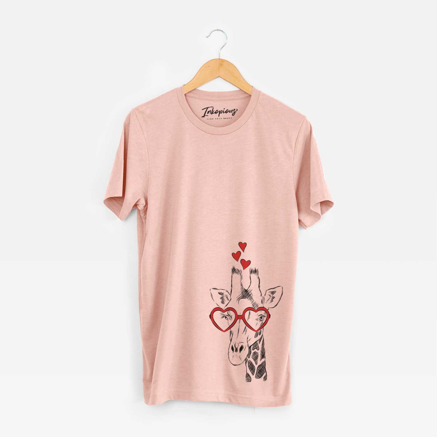Hand-drawn sketch of Geoffrey the Giraffe wearing heart-shaped glasses on a Peach Unisex crewneck