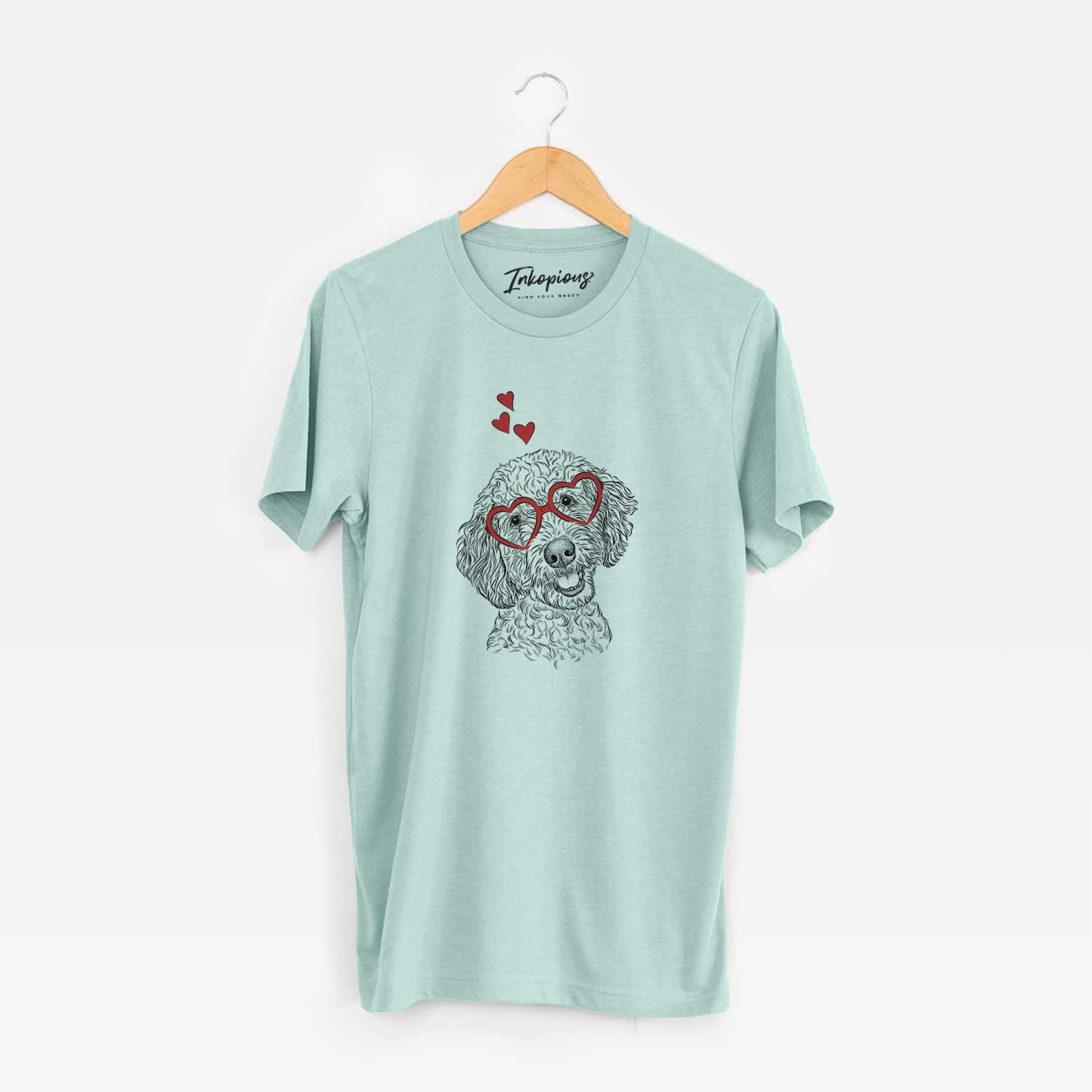 Hand-drawn sketch of Gizmo the Goldendoodle wearing heart-shaped glasses on a Heather Sage Unisex crewneck