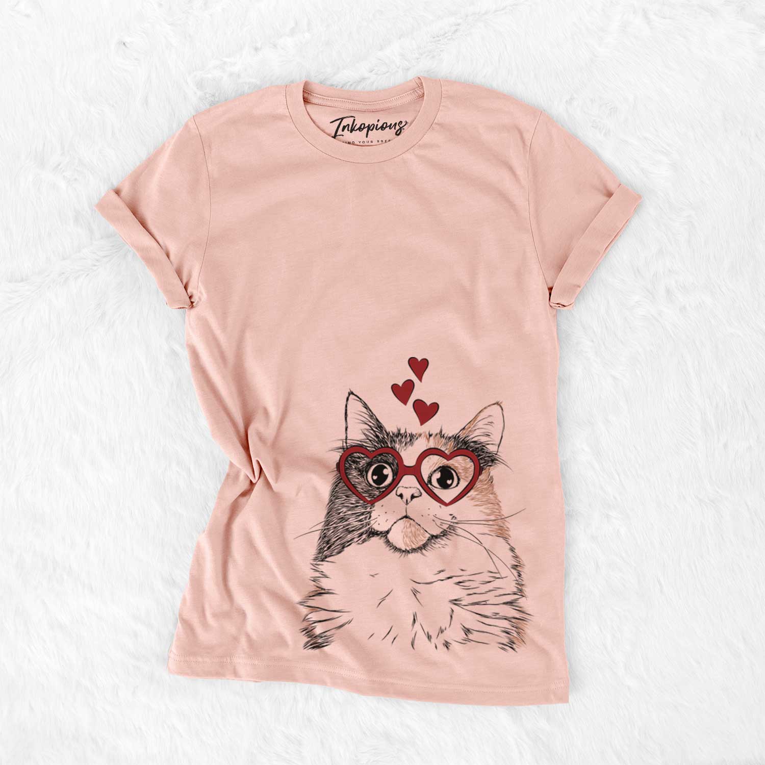 Hand-drawn sketch of Greta the Calico Cat wearing heart-shaped glasses on a Peach Bella Canvas Unisex Crewneck