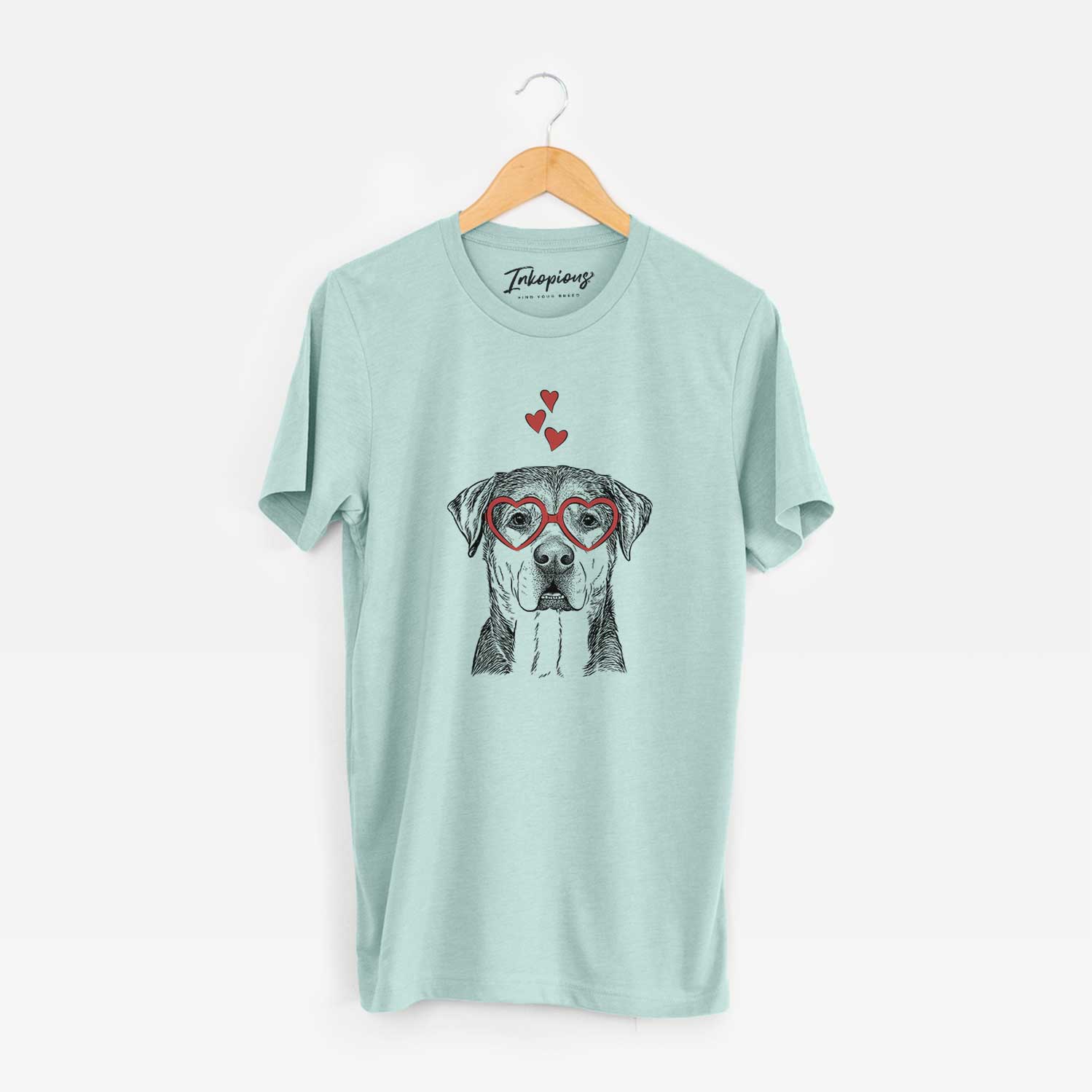 Hand-drawn sketch of Gus the Rottweiler Mix wearing heart-shaped glasses on a Heather Sage Unisex crewneck