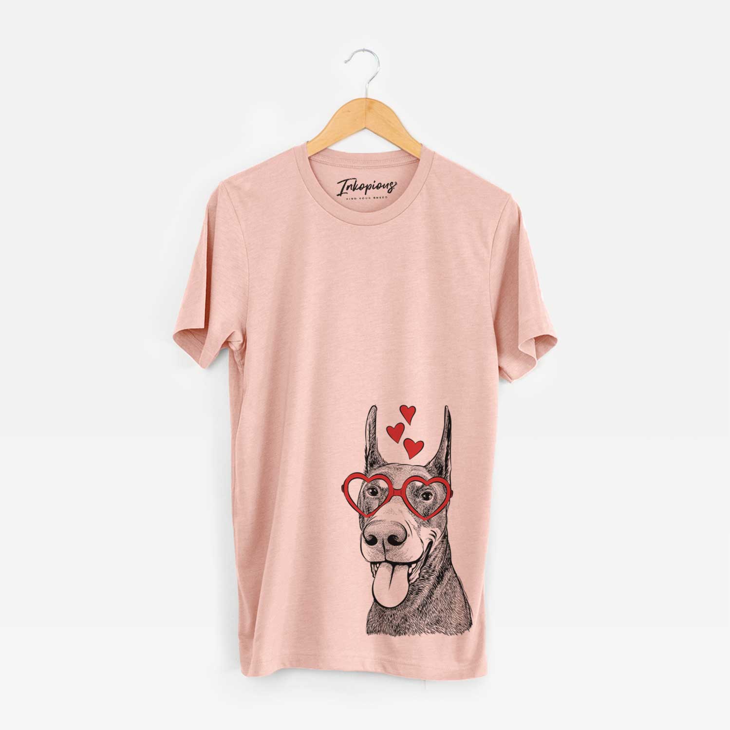 Hand-drawn sketch of Happy Sunny the Doberman Pinscher wearing heart-shaped glasses on a Peach Unisex crewneck