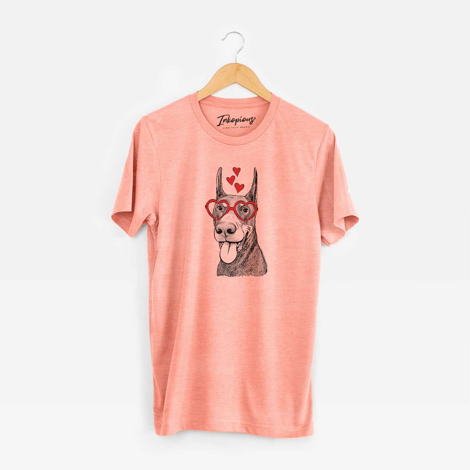 Hand-drawn sketch of Happy Sunny the Doberman Pinscher wearing heart-shaped glasses on a Sunset Unisex crewneck