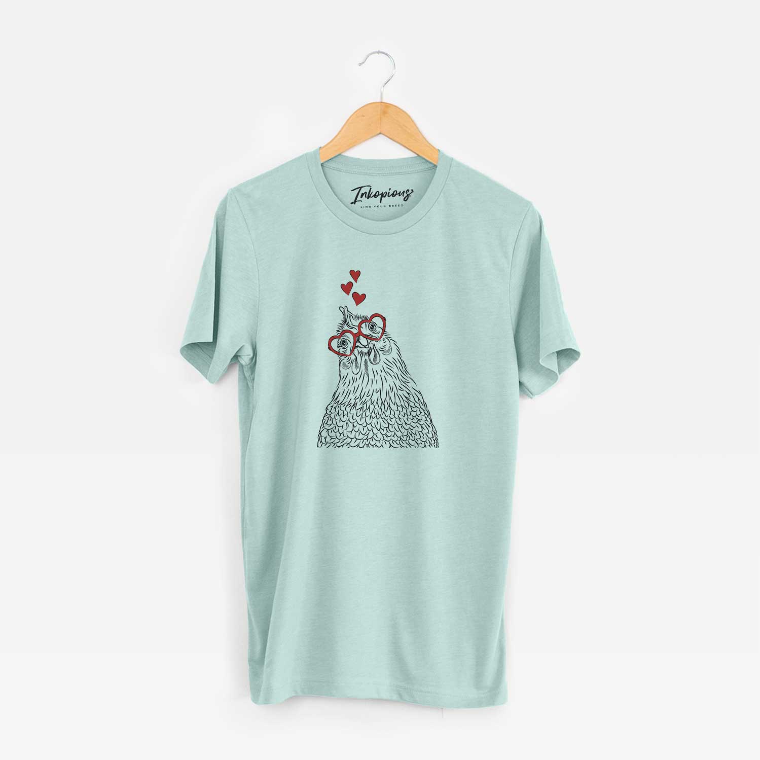 Hand-drawn sketch of Henrietta the Chicken wearing heart-shaped glasses on a Heather Sage Unisex crewneck