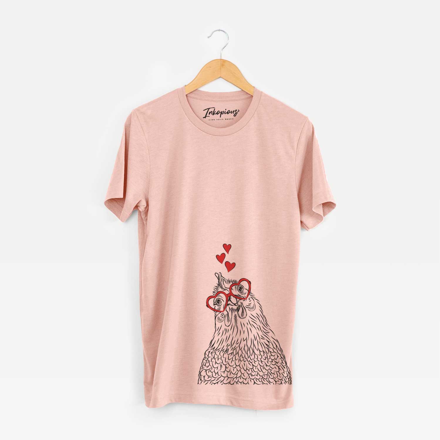 Hand-drawn sketch of Henrietta the Chicken wearing heart-shaped glasses on a Peach Unisex crewneck