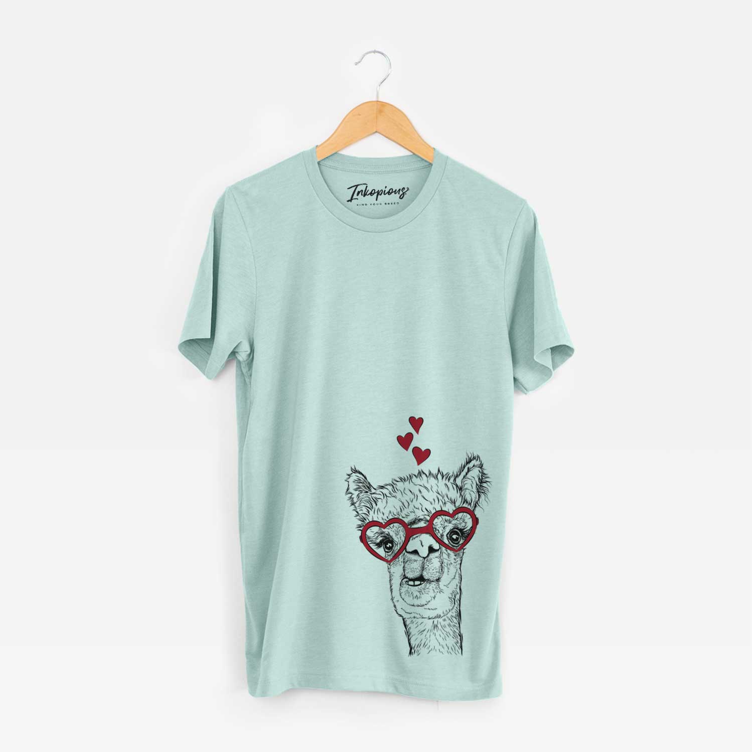 Hand-drawn sketch of Henry the Alpaca wearing heart-shaped glasses on a Heather Sage Bella Canvas Unisex Crewneck