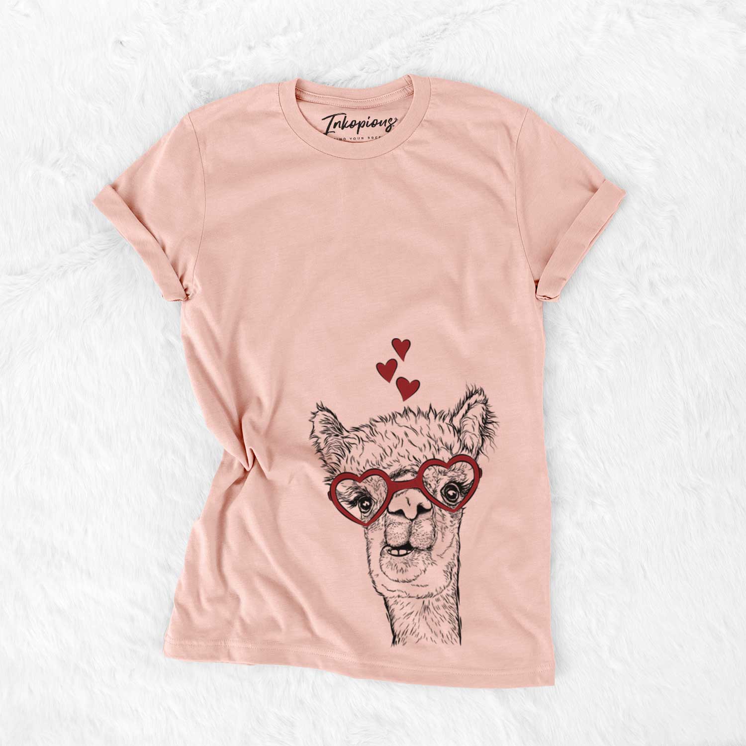 Hand-drawn sketch of Henry the Alpaca wearing heart-shaped glasses on a Peach Bella Canvas Unisex Crewneck
