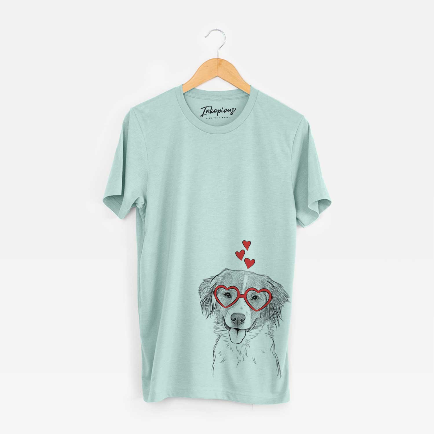 Hand-drawn sketch of Hercules the Nederlandse Kooikerhondje wearing heart-shaped glasses on a Heather Sage Unisex crewneck