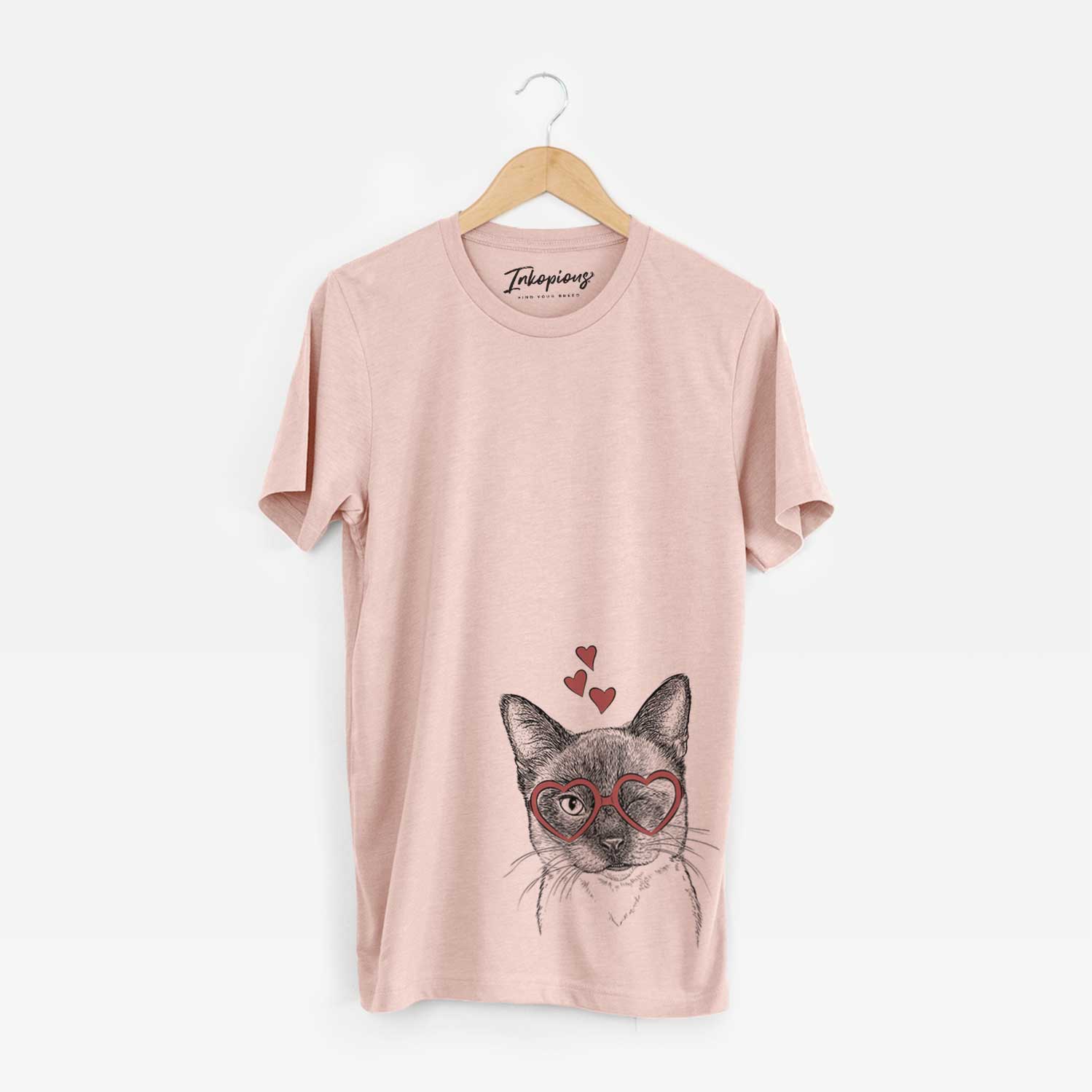 Hand-drawn sketch of Hoggle the Siamese Cat wearing heart-shaped glasses on a Peach Unisex crewneck