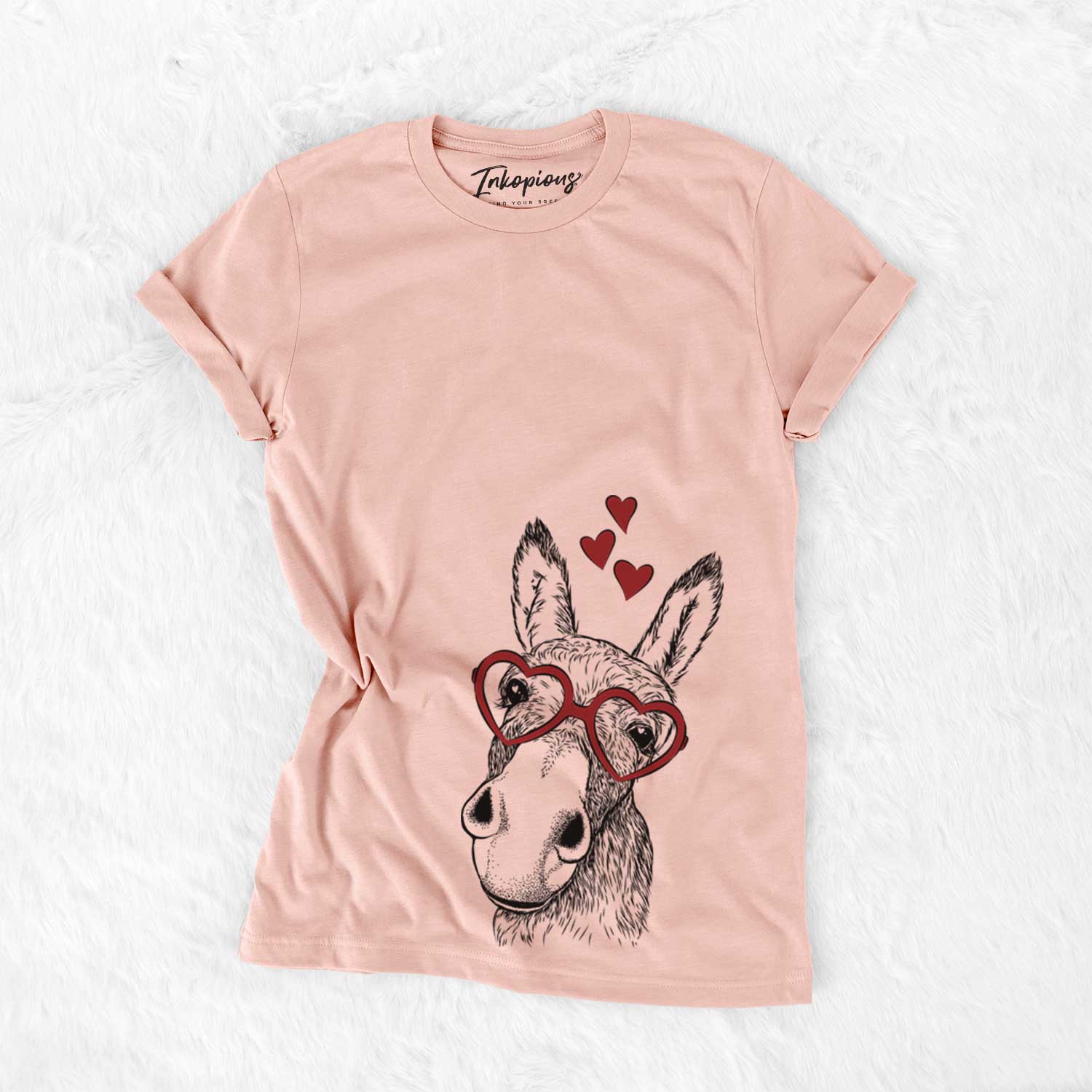 Hand-drawn sketch of Jenny the Donkey wearing heart-shaped glasses on a Peach Bella Canvas Unisex Crewneck